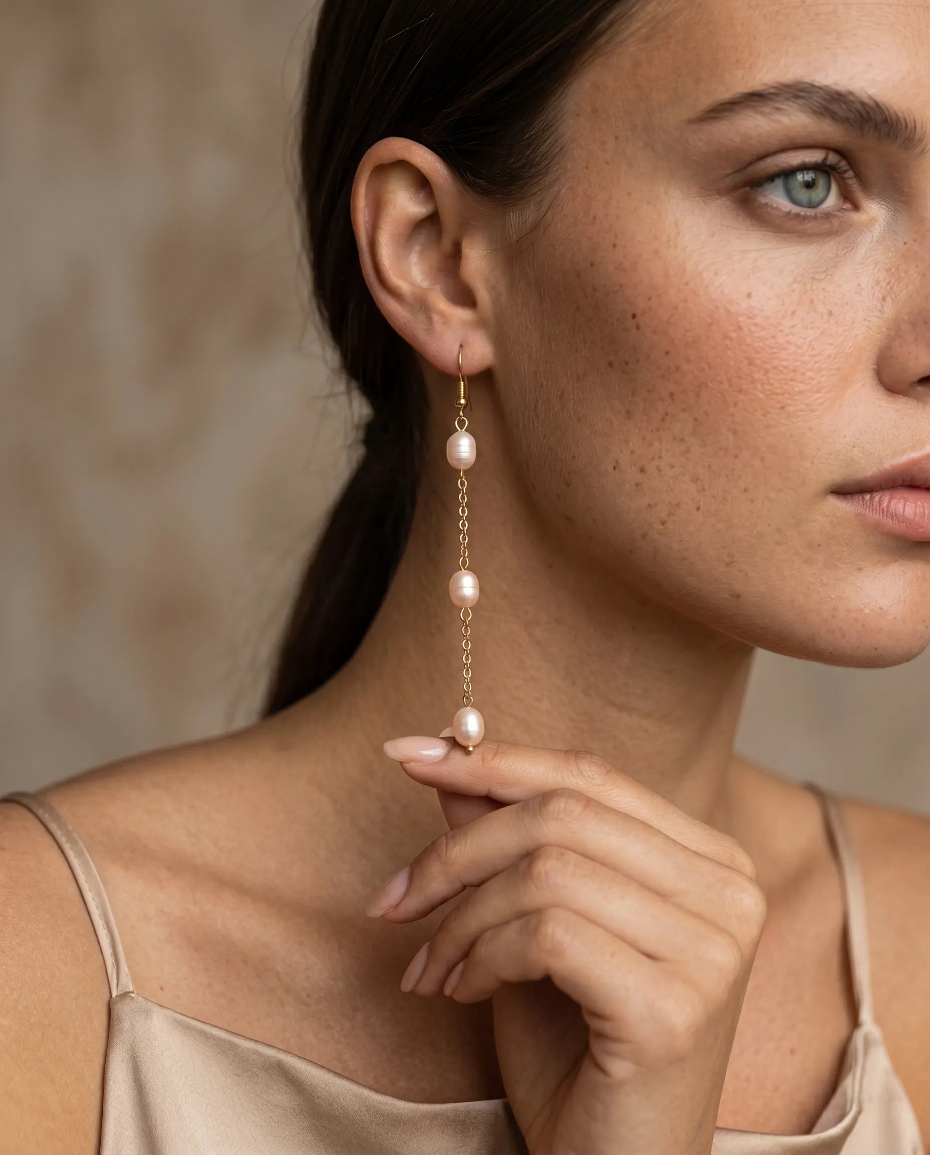 close-up-of-miriam-pearl-drop-earrings-worn-by-model-to-emphasize-length-and-fluid-movement-minimalist-luxury