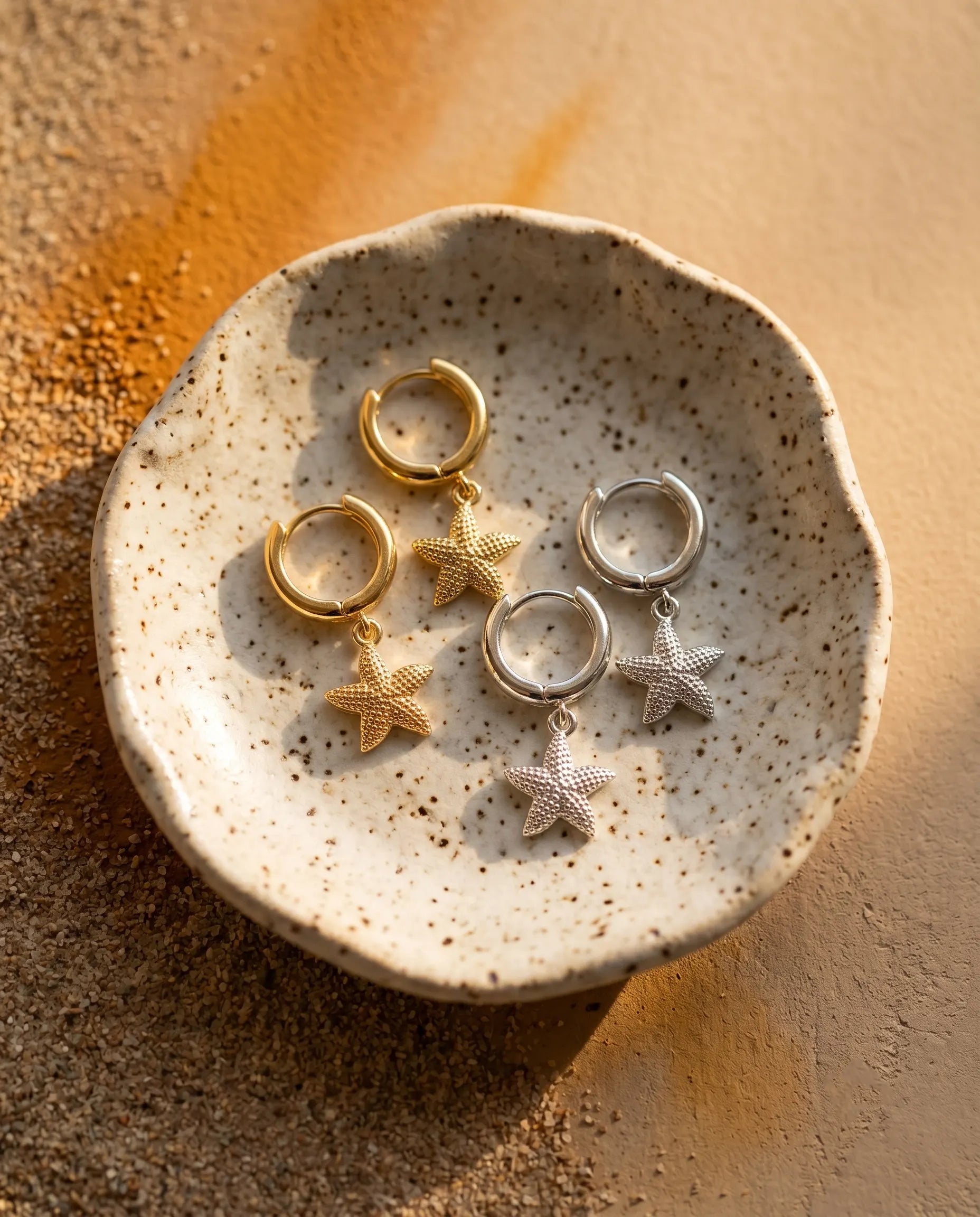 close-up-of-nerella-starfish-earrings-displayed-on-minimalist-dish-highlighting-the-organic-design-and-sterling-silver-quality