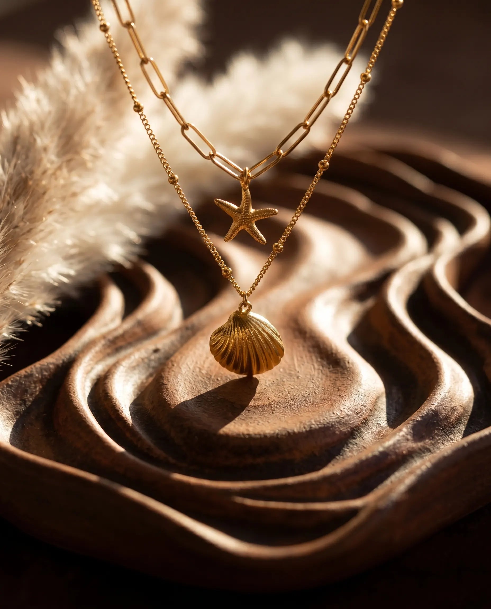 close-up-view-of-sunae-necklace-charms-and-textured-chains-highlighting-gold-finish-and-durable-stainless-steel-quality