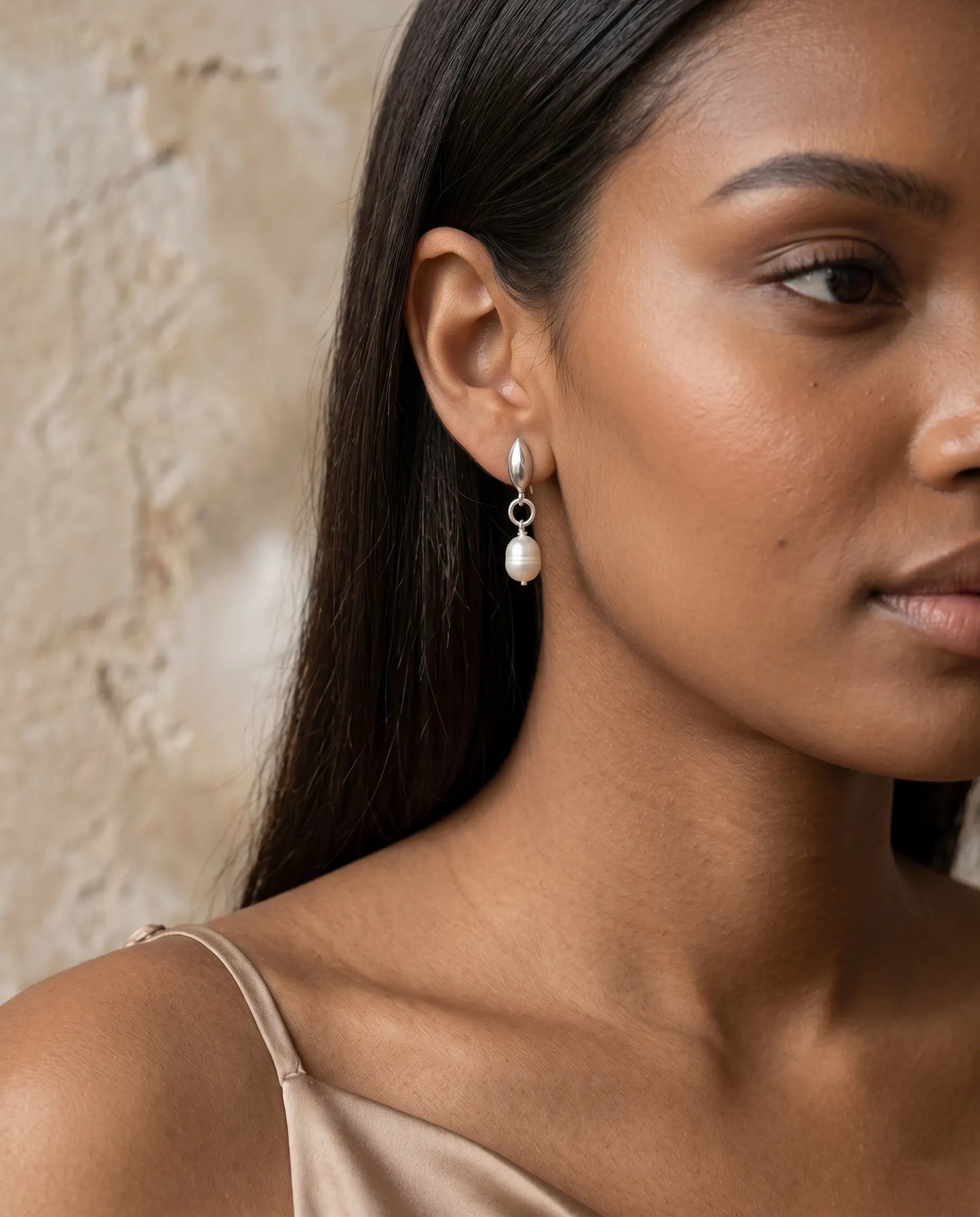 closeup-front-view-model-wearing-gold-petal-pearl-earrings, glowing-elegant-daily-wear-gold-jewelry-europe, luxury-women-professional-jewelry, feminine-architectural-statement-studs