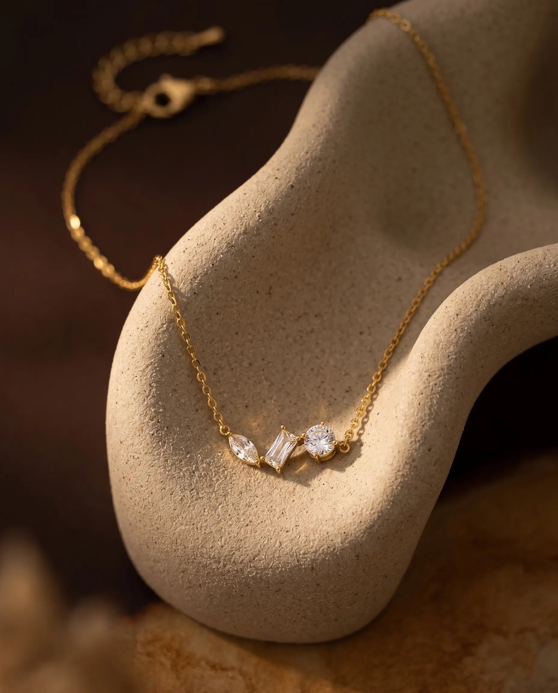 closeup-of-delicate-crystal-pendant-gold-necklace-18k-plated, high-end-waterproof-stainless-steel-jewelry-detail, senya-jewelry-signature-elegant-necklace-design