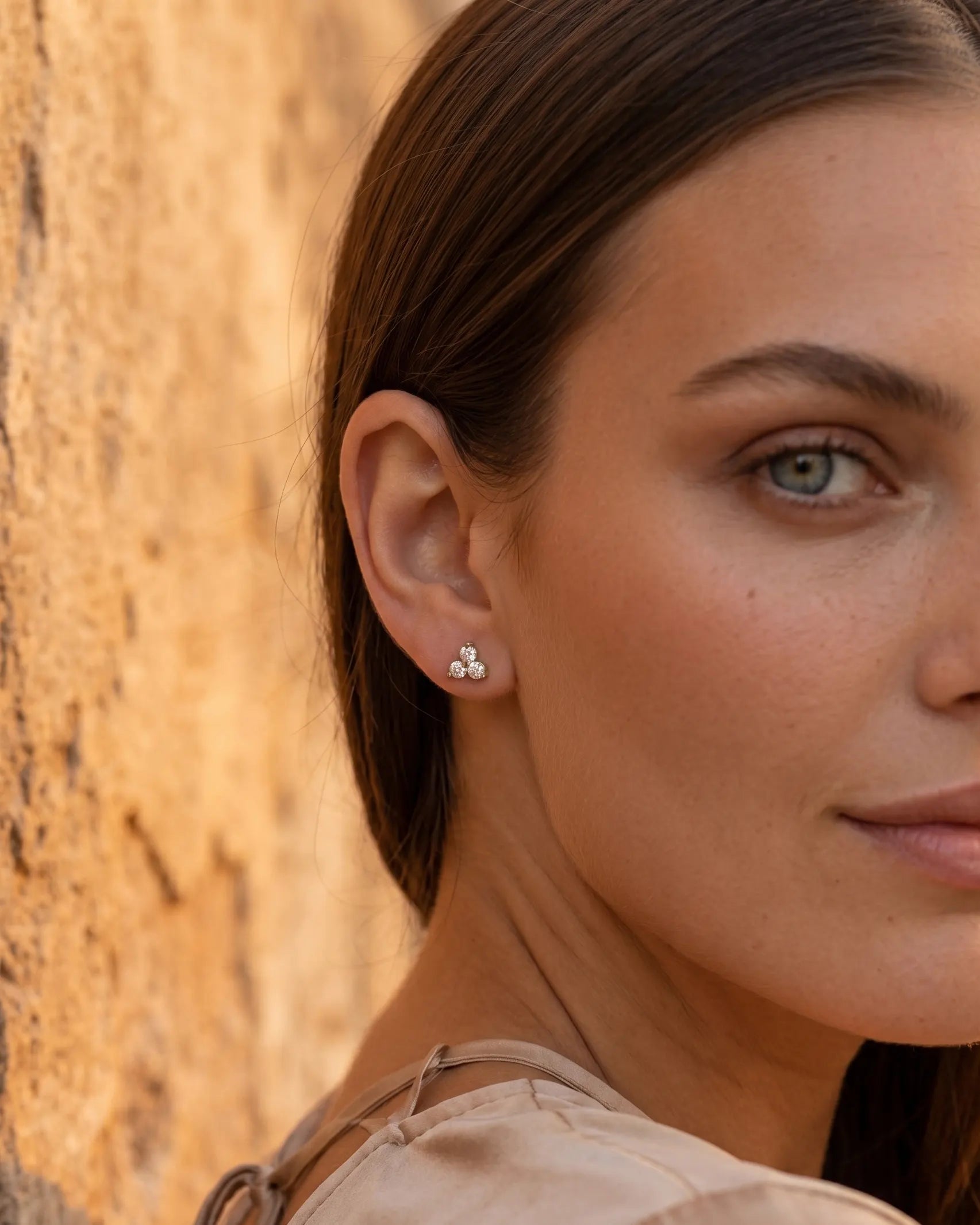closeup-side-view-model-wearing-silver-blossom-stud-earrings, glowing-elegant-daily-wear-silver-jewelry-europe, luxury-women-professional-jewelry, feminine-minimalist-floral-studs
