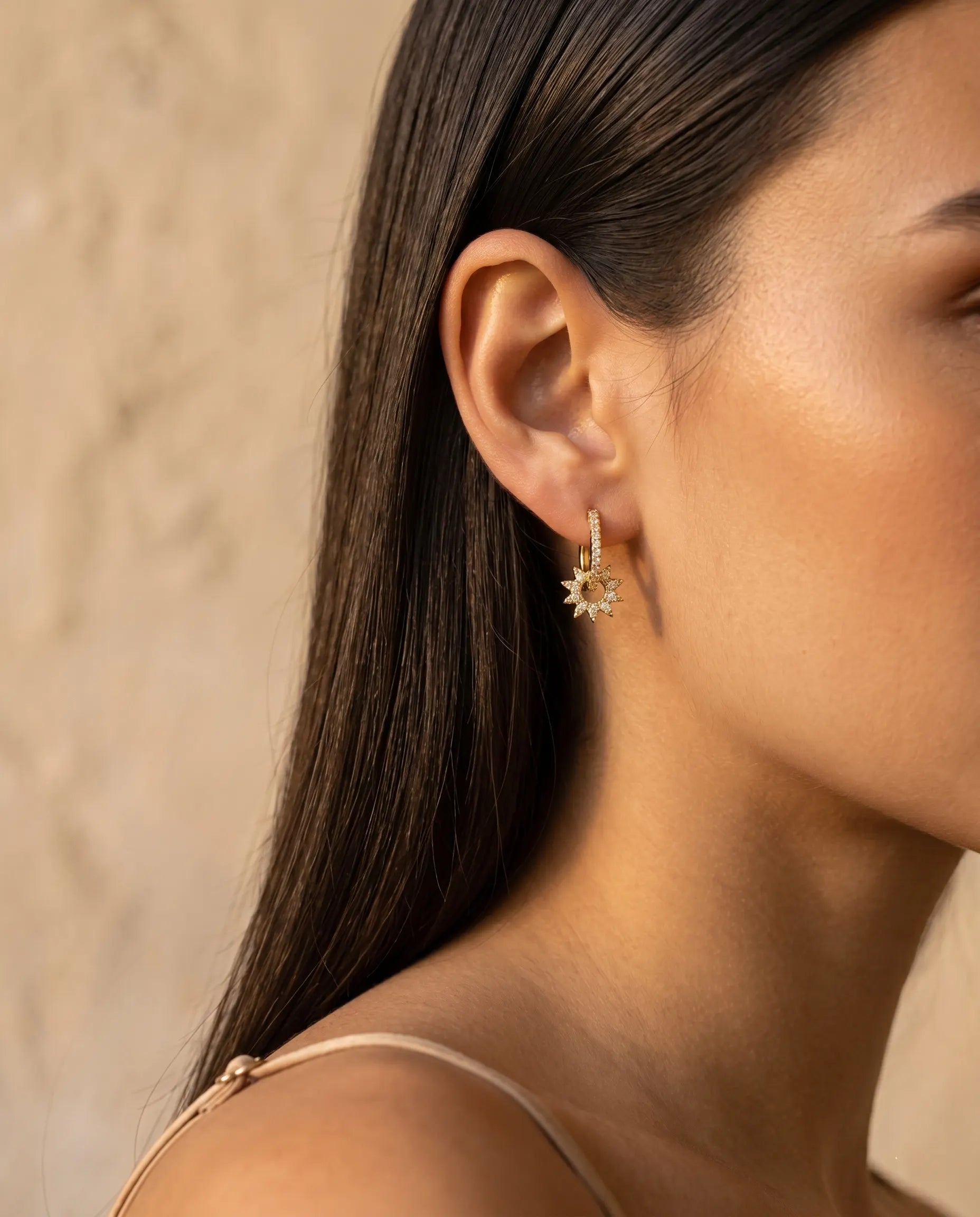 closeup-side-view-model-wearing-silver-sunlight-huggie-earrings_glowing-elegant-daily-wear-silver-jewelry-europe_luxury-women-professional-jewelry_feminine-architectural-celestial-hoops