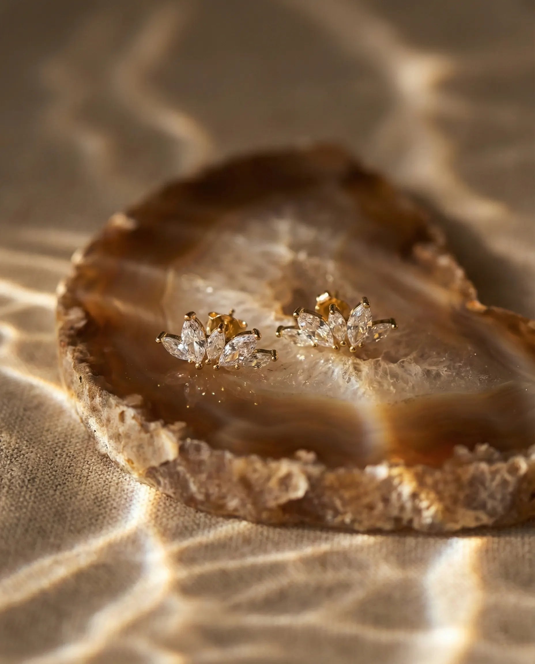 marquise-cut-crystal-stud-earrings-captured-in-warm-natural-light-to-emphasize-the-floral-geometric-design