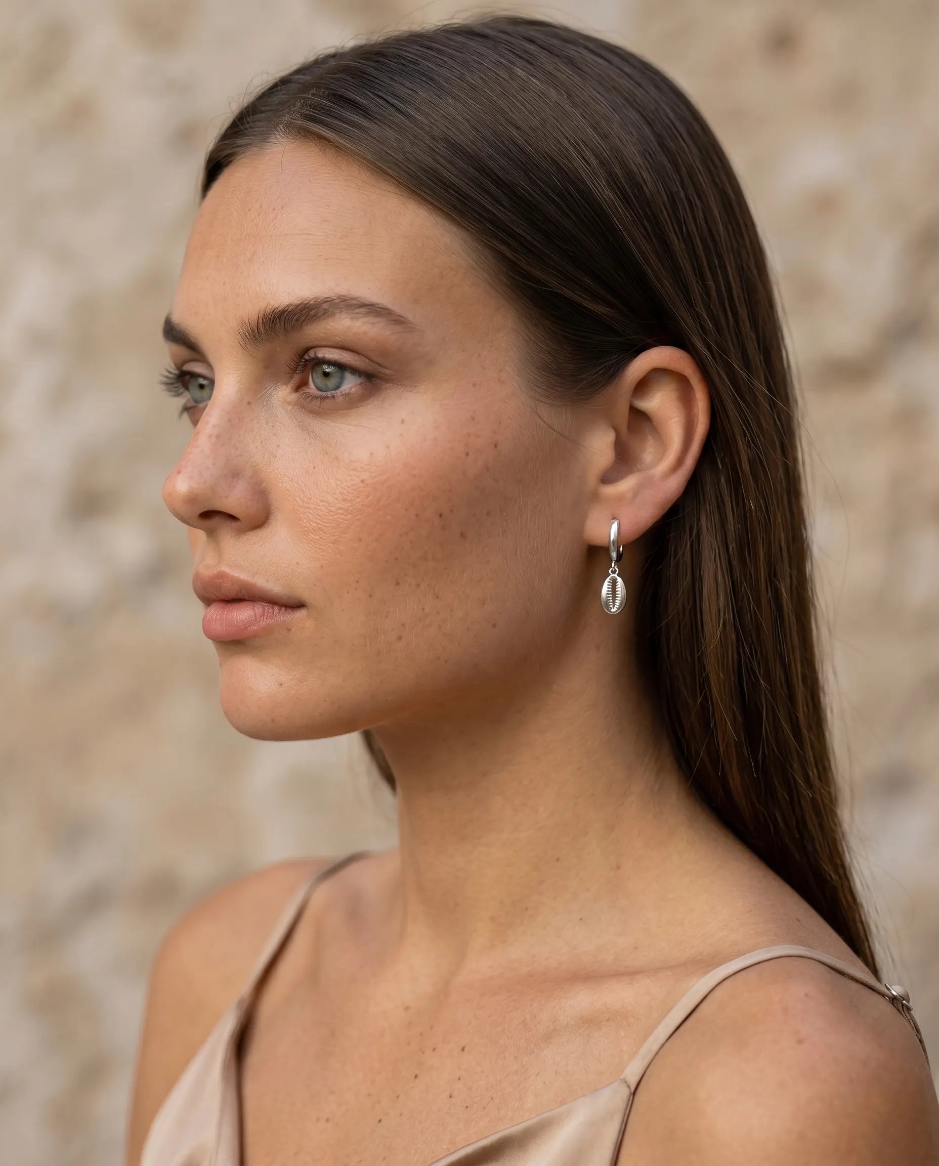 model-profile-wearing-sand-cowrie-shell-earrings-minimalist-everyday-luxury-jewelry-style-for-modern-women