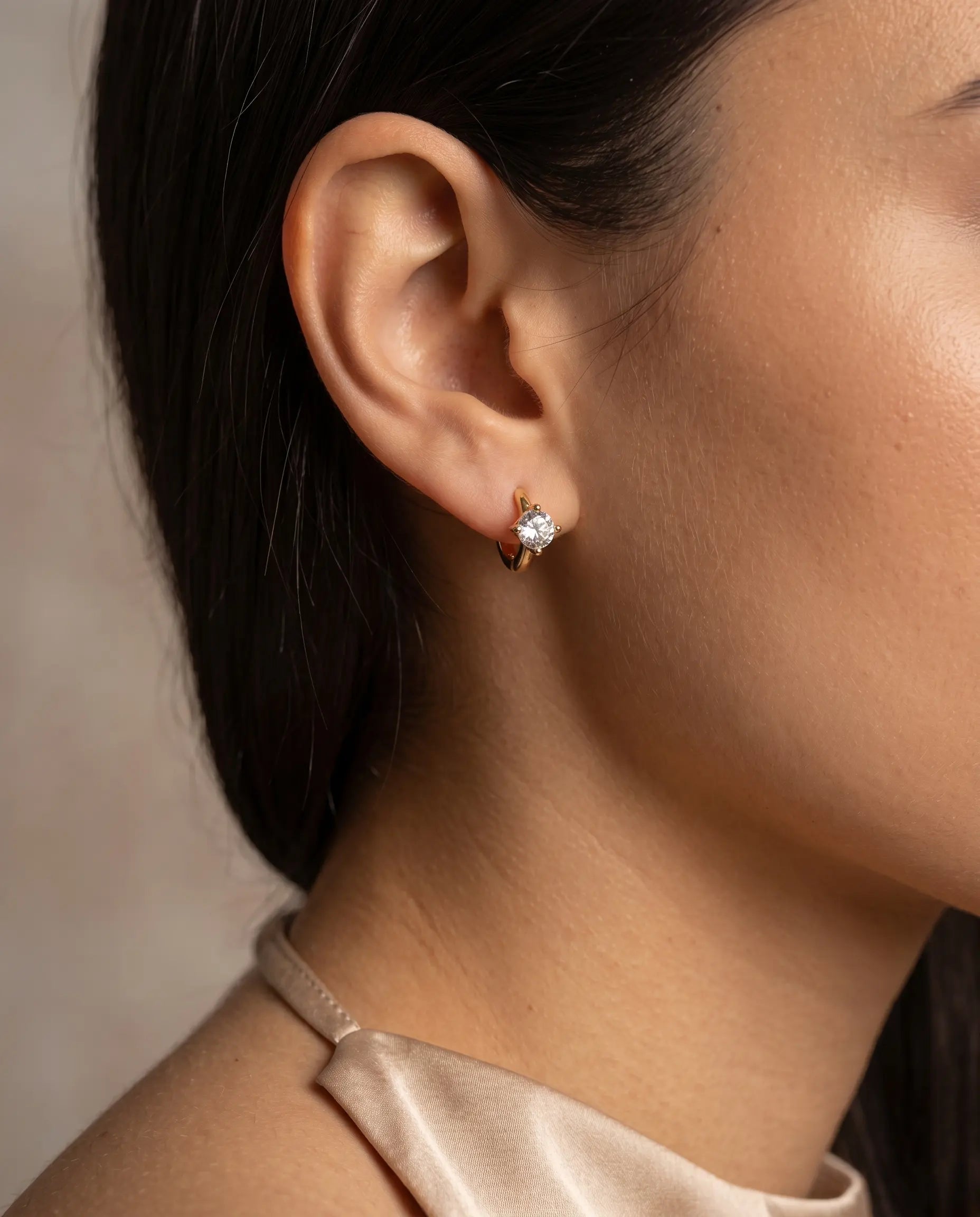 model-wearing-cara-gold-knot-stud-earrings-lifestyle, elegant-modern-feminine-jewelry-on-ear, professional-women-luxury-accessories, chic-small-gold-knot-styling, luxury-lifestyle-brand-model