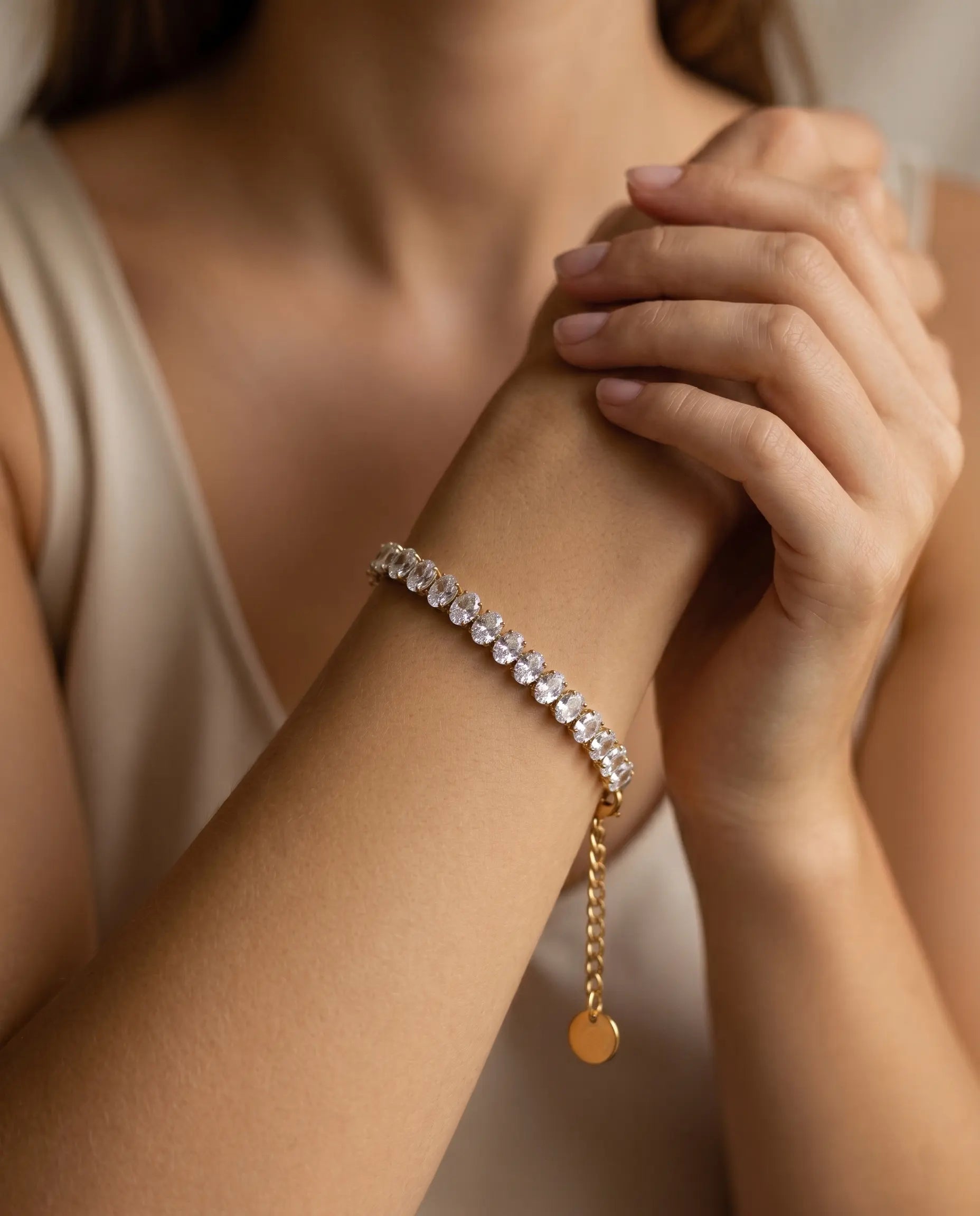 model-wearing-gold-breena-tennis-bracelet-lifestyle, elegant-modern-feminine-jewelry-on-wrist, professional-women-luxury-accessories, chic-gold-crystal-bracelet-styling, luxury-lifestyle-brand-model