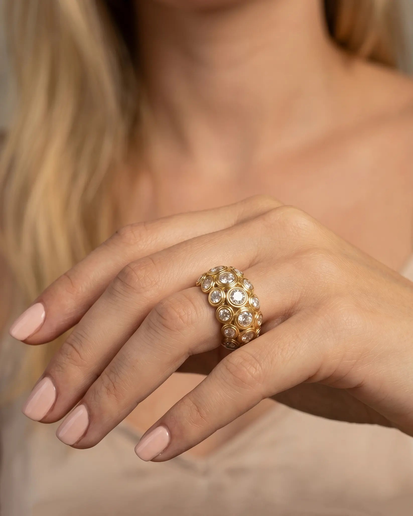 model-wearing-gold-calytrix-oval-halo-ring-lifestyle, elegant-modern-celestial-jewelry-on-hand, professional-women-luxury-accessories, chic-gold-solitaire-styling, luxury-lifestyle-brand-model