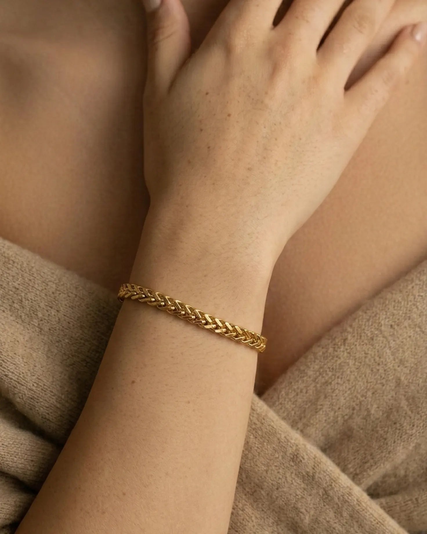 model-wearing-gold-cordira-twisted-bracelet, elegant-effortless-style-jewelry-lifestyle, professional-women-luxury-accessories, chic-minimalist-bracelet-stack-photography, luxury-lifestyle-brand-model