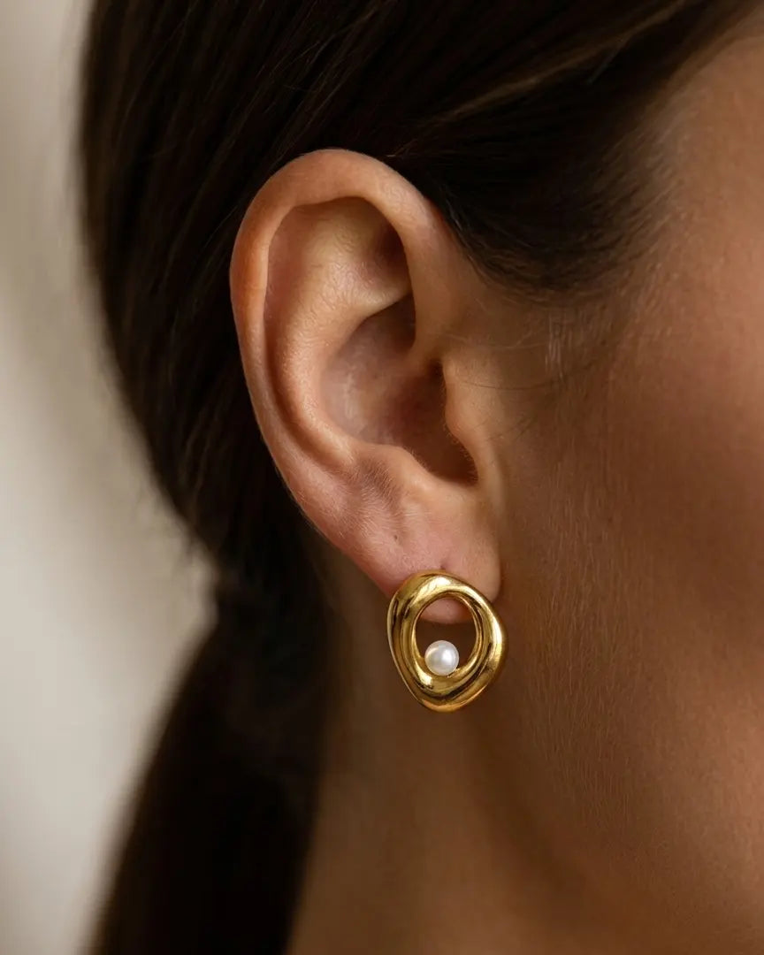 model-wearing-gold-cybelle-teardrop-earrings-lifestyle, elegant-modern-feminine-jewelry-on-ear, professional-women-luxury-accessories, chic-liquid-gold-styling, luxury-lifestyle-brand-model