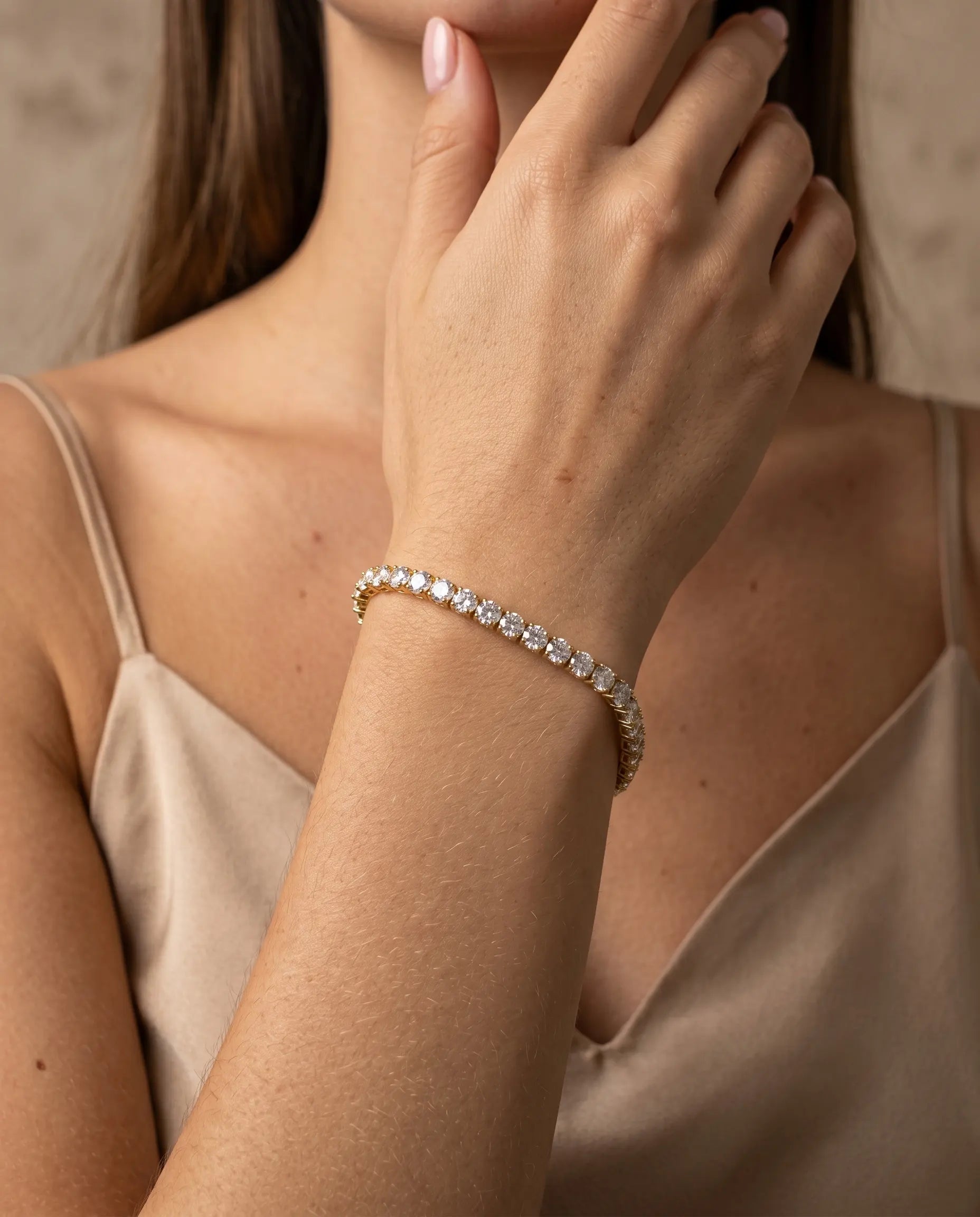 model-wearing-gold-elena-tennis-bracelet-lifestyle, elegant-modern-feminine-jewelry-on-wrist, professional-women-luxury-accessories, chic-gold-crystal-styling, luxury-lifestyle-brand-model