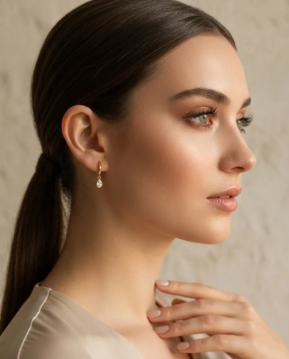 model-wearing-gold-fairy-teardrop-huggie-earrings, elegant-sparkling-jewelry-lifestyle, professional-women-delicate-earrings, chic-minimalist-accessories-photography, luxury-lifestyle-brand-model, premium-crystal-drop-huggies