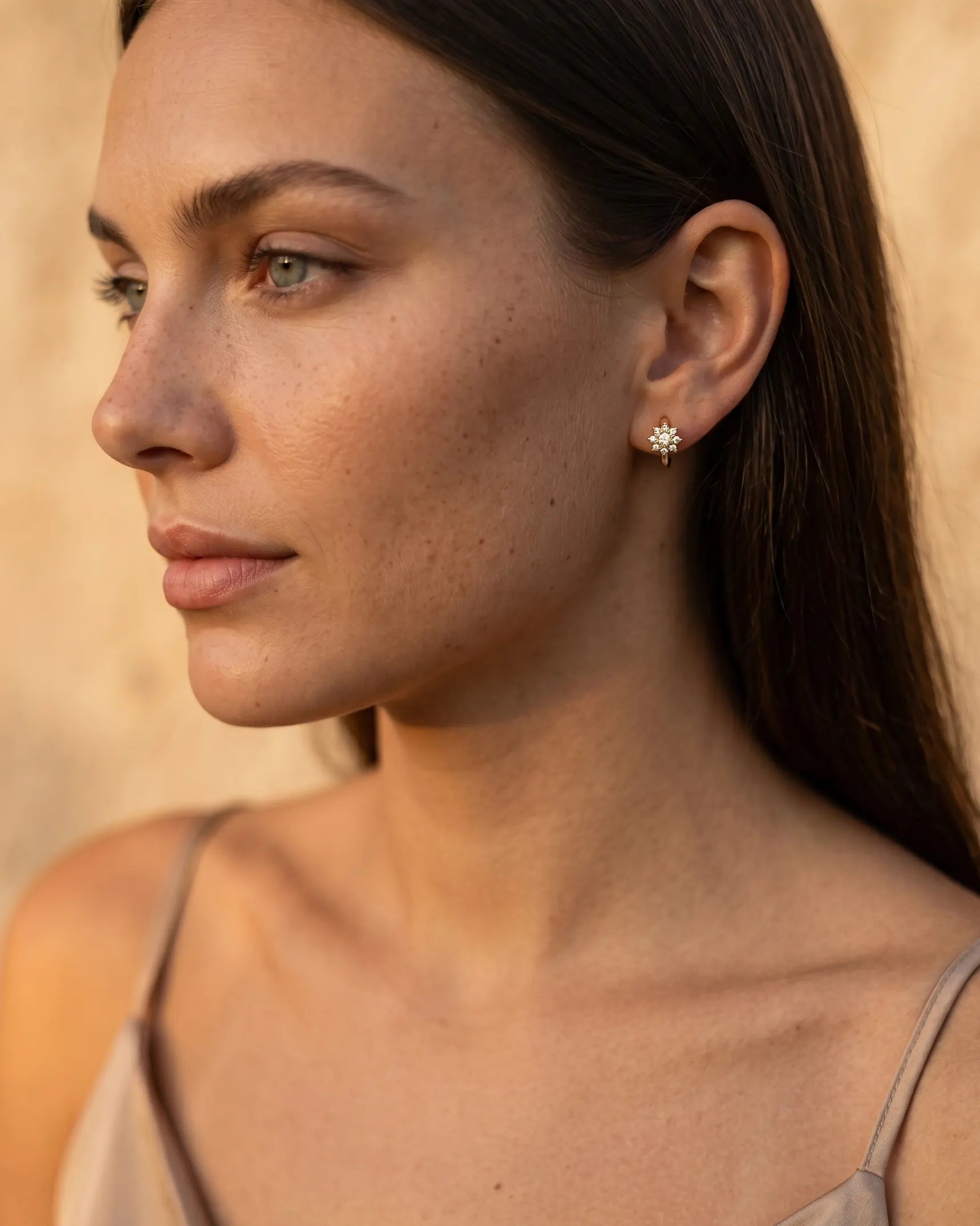 model-wearing-gold-felicia-flower-hoops-lifestyle, elegant-modern-feminine-jewelry-on-ear, professional-women-luxury-accessories, chic-crystal-floral-earrings-styling, luxury-lifestyle-brand-model