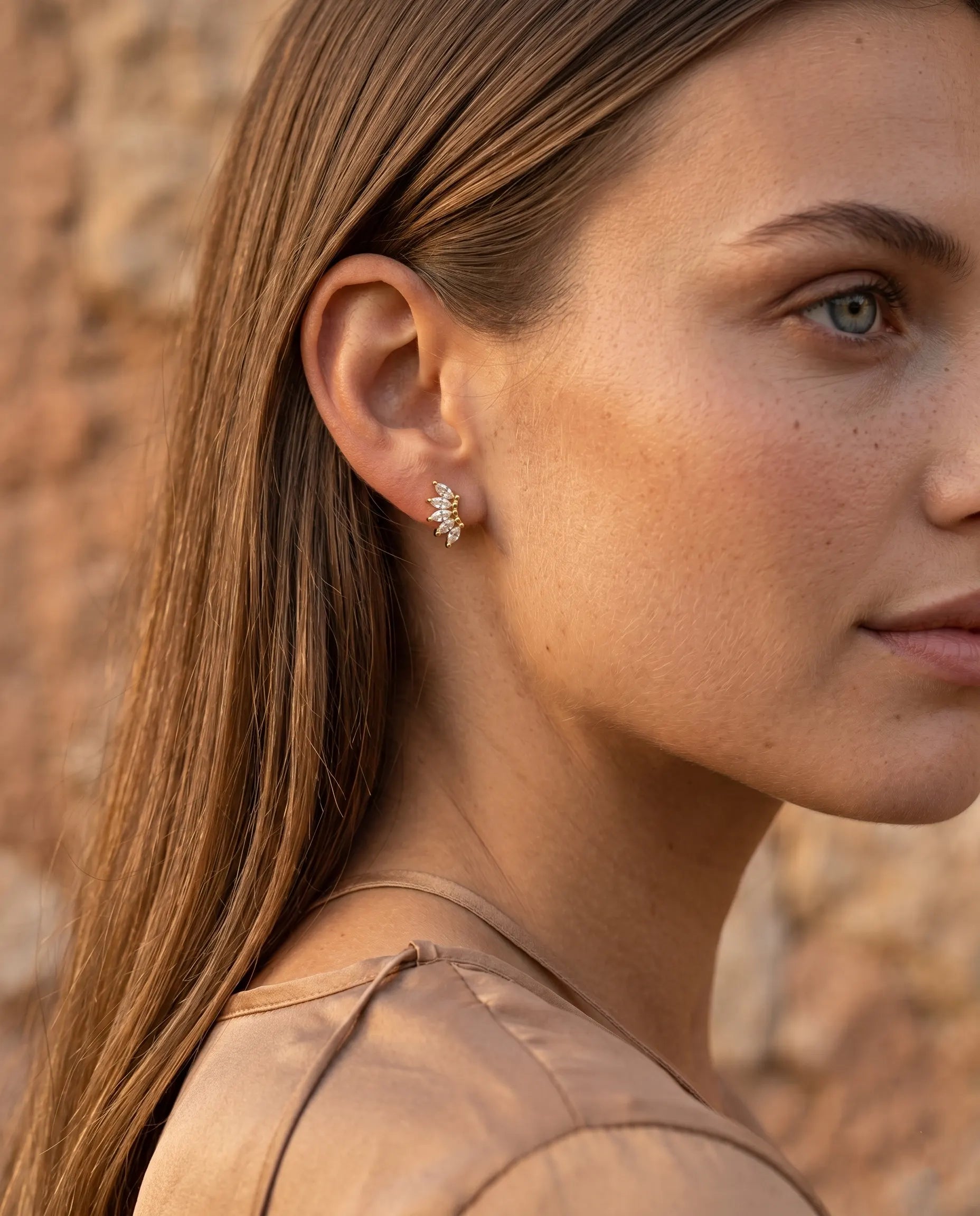 model-wearing-gold-laynie-star-huggies, elegant-celestial-jewelry-lifestyle, professional-women-jewelry-style, chic-starburst-ear-stack-photography, luxury-lifestyle-brand-model