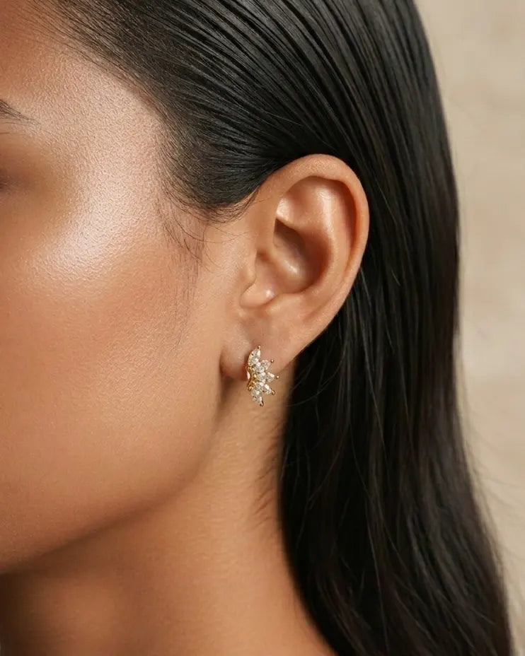 model-wearing-gold-laynie-star-huggies, elegant-celestial-jewelry-lifestyle, professional-women-jewelry-style, chic-starburst-ear-stack-photography, luxury-lifestyle-brand-model