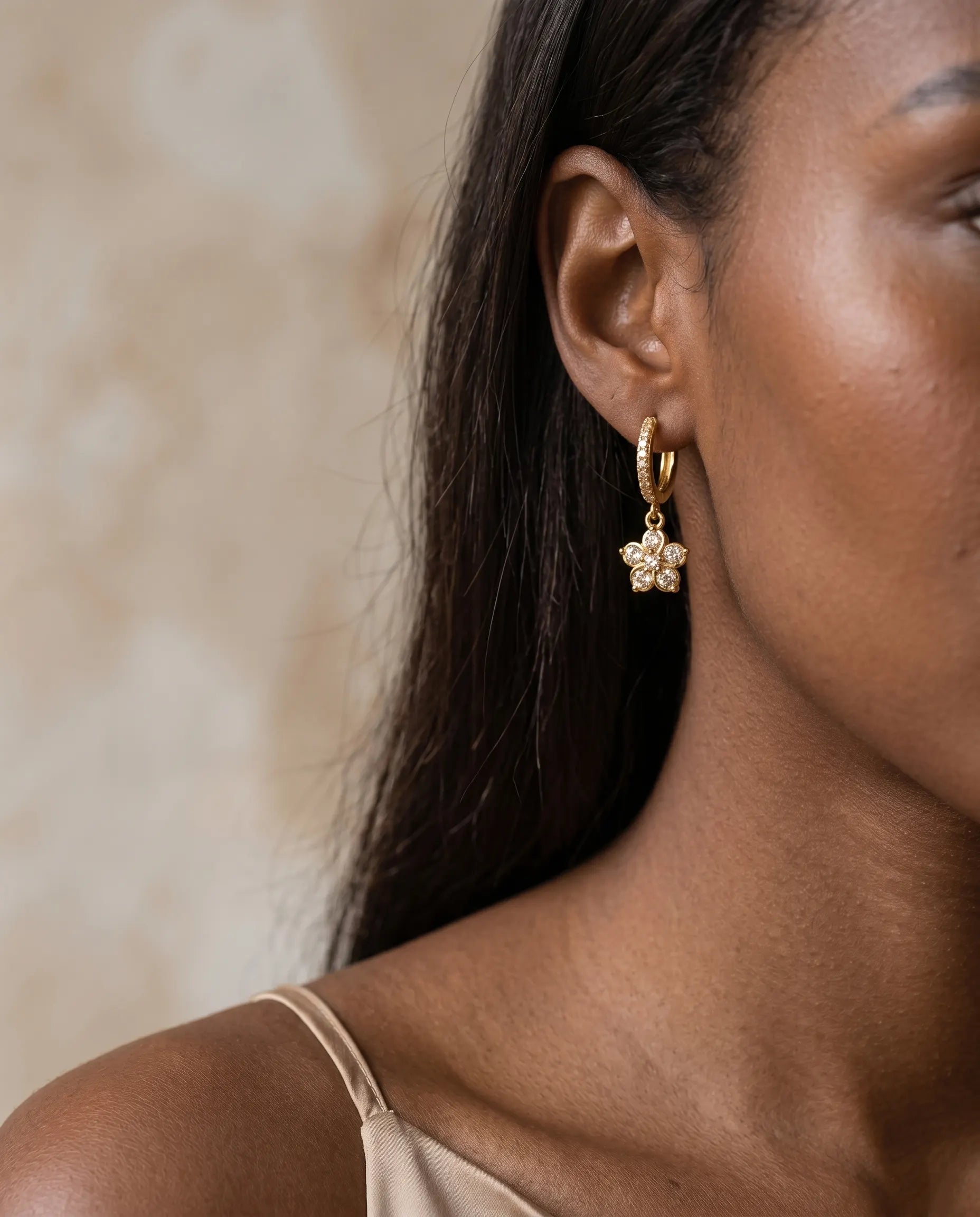 model-wearing-gold-marie-flower-drop-earrings-lifestyle, elegant-modern-feminine-jewelry-on-ear, professional-women-luxury-accessories, chic-floral-gold-styling, luxury-lifestyle-brand-model