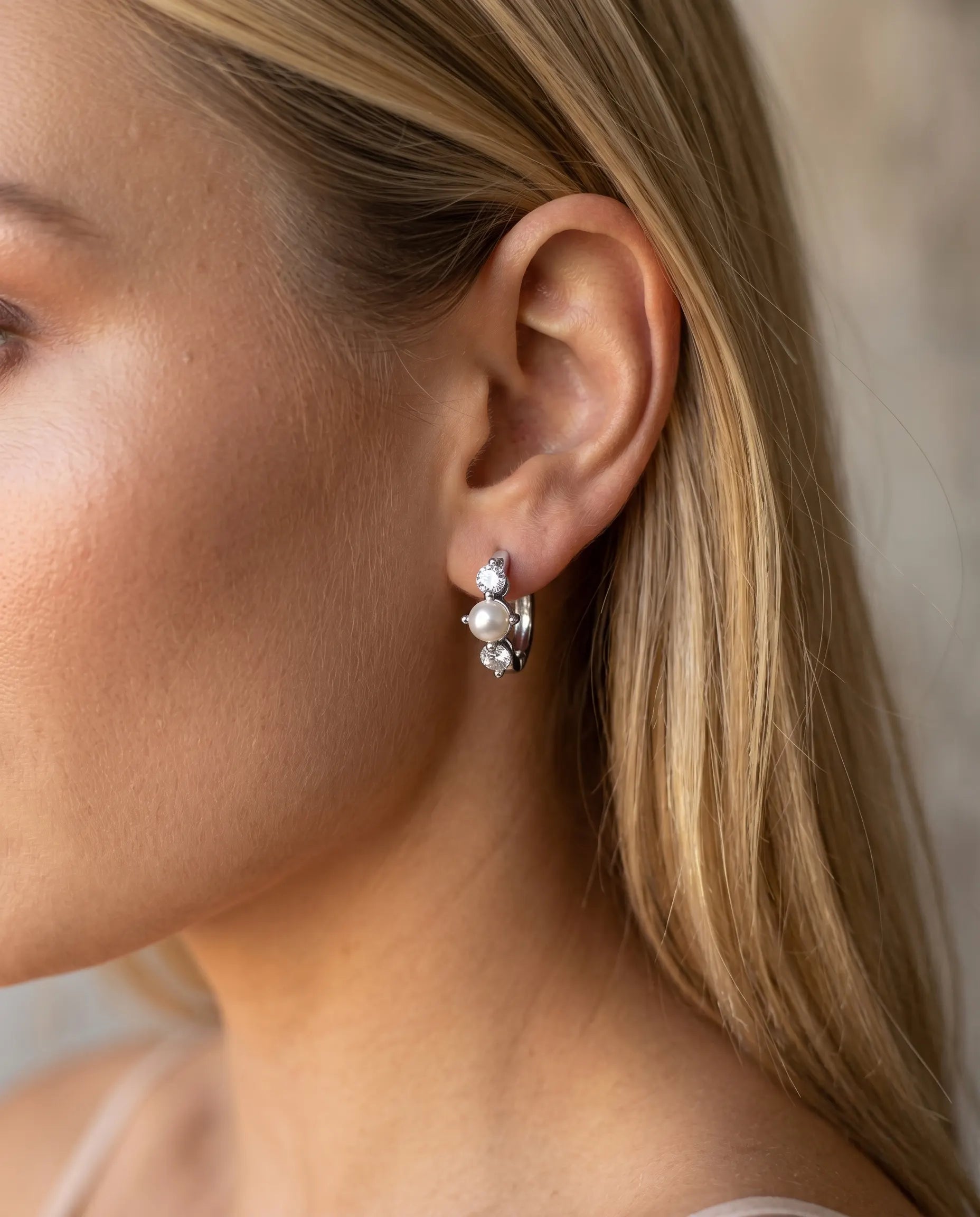 model-wearing-gold-nana-pearl-zirconia-hoops, elegant-timeless-pearl-jewelry-lifestyle, professional-women-wedding-style, chic-minimalist-accessories-photography, luxury-lifestyle-brand-model