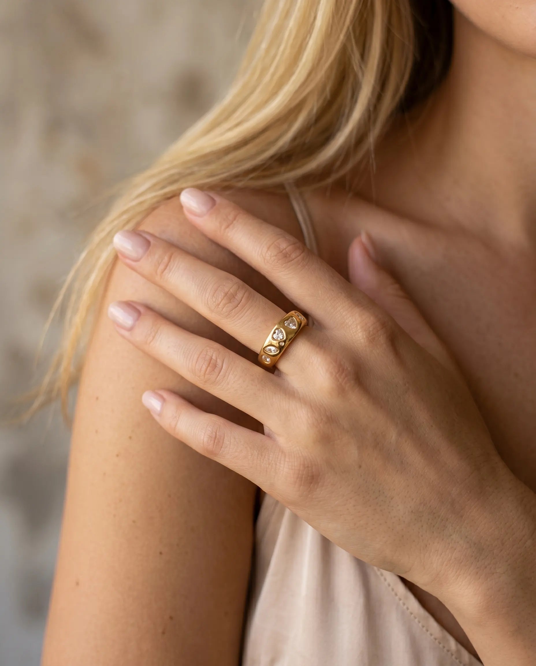 model-wearing-gold-paloma-heart-ring-lifestyle, elegant-modern-romantic-jewelry-on-hand, professional-women-luxury-accessories, chic-adjustable-gold-ring-styling, luxury-lifestyle-brand-model