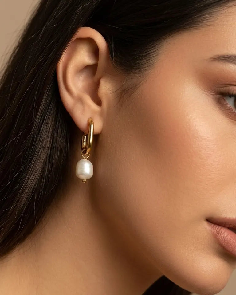 model-wearing-gold-pearly-earrings-lifestyle, elegant-modern-coastal-jewelry-on-ear, professional-women-luxury-accessories, chic-gold-pearl-drop-styling, luxury-lifestyle-brand-model