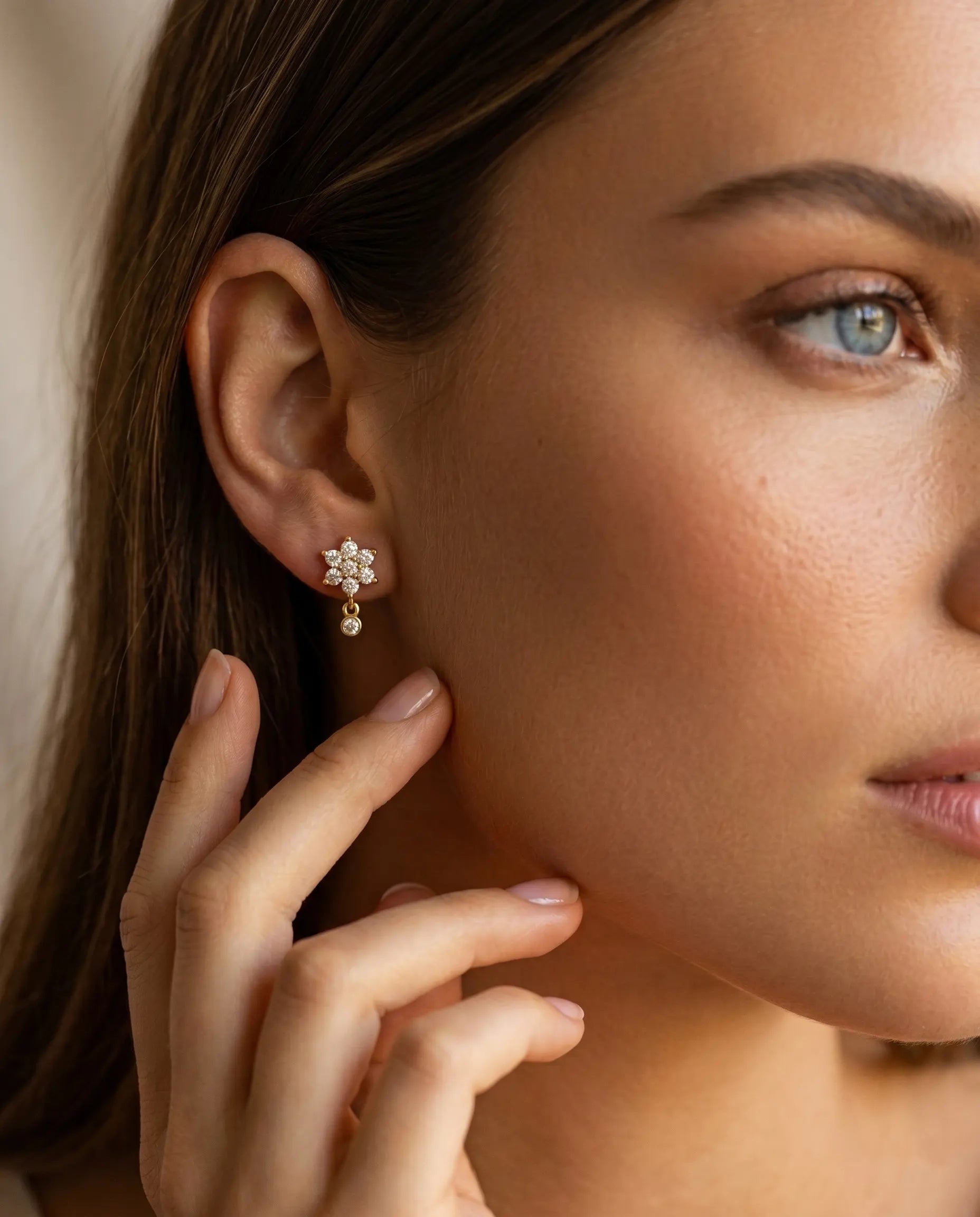 model-wearing-gold-sakura-floral-drop-earrings-lifestyle, elegant-modern-feminine-jewelry-on-ear, professional-women-luxury-accessories, chic-botanical-gold-styling, luxury-lifestyle-brand-model