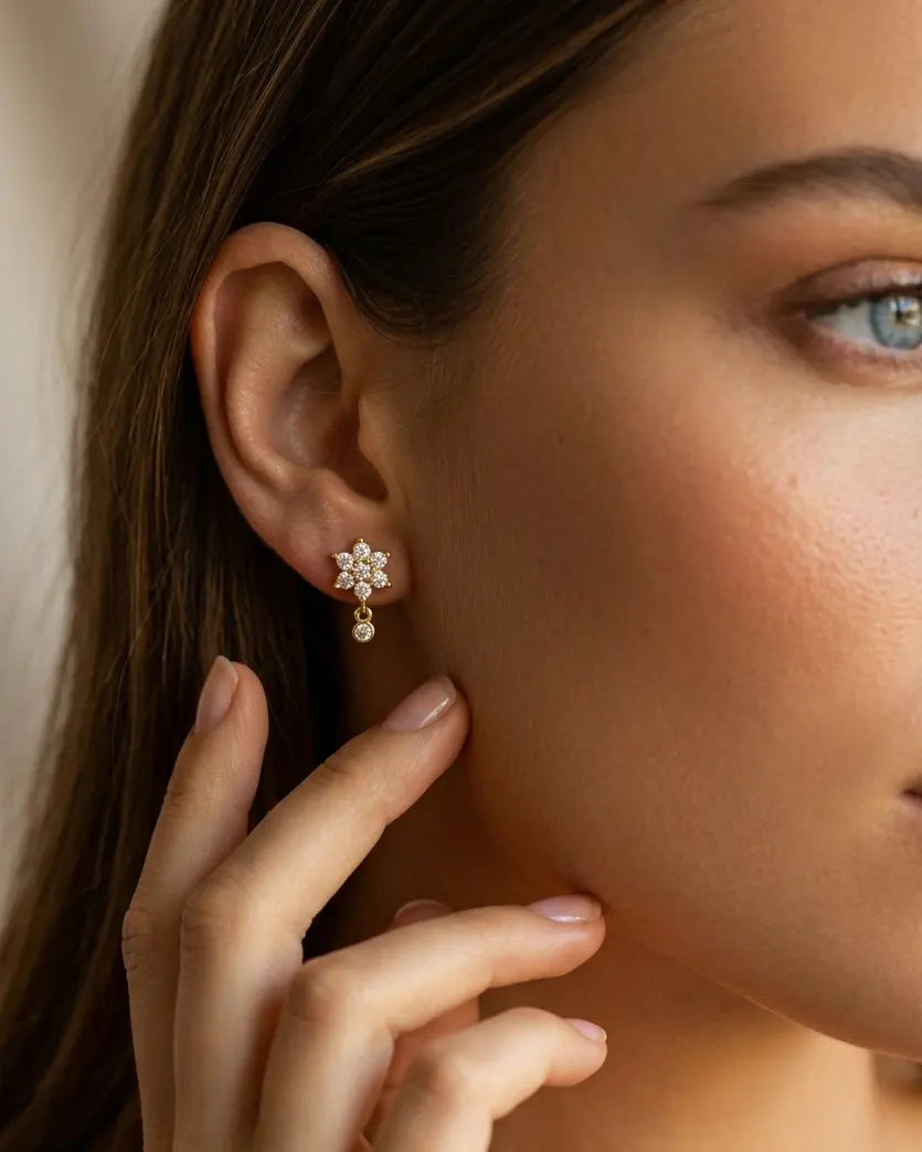 model-wearing-gold-sakura-floral-drop-earrings-lifestyle, elegant-modern-feminine-jewelry-on-ear, professional-women-luxury-accessories, chic-botanical-gold-styling, luxury-lifestyle-brand-model