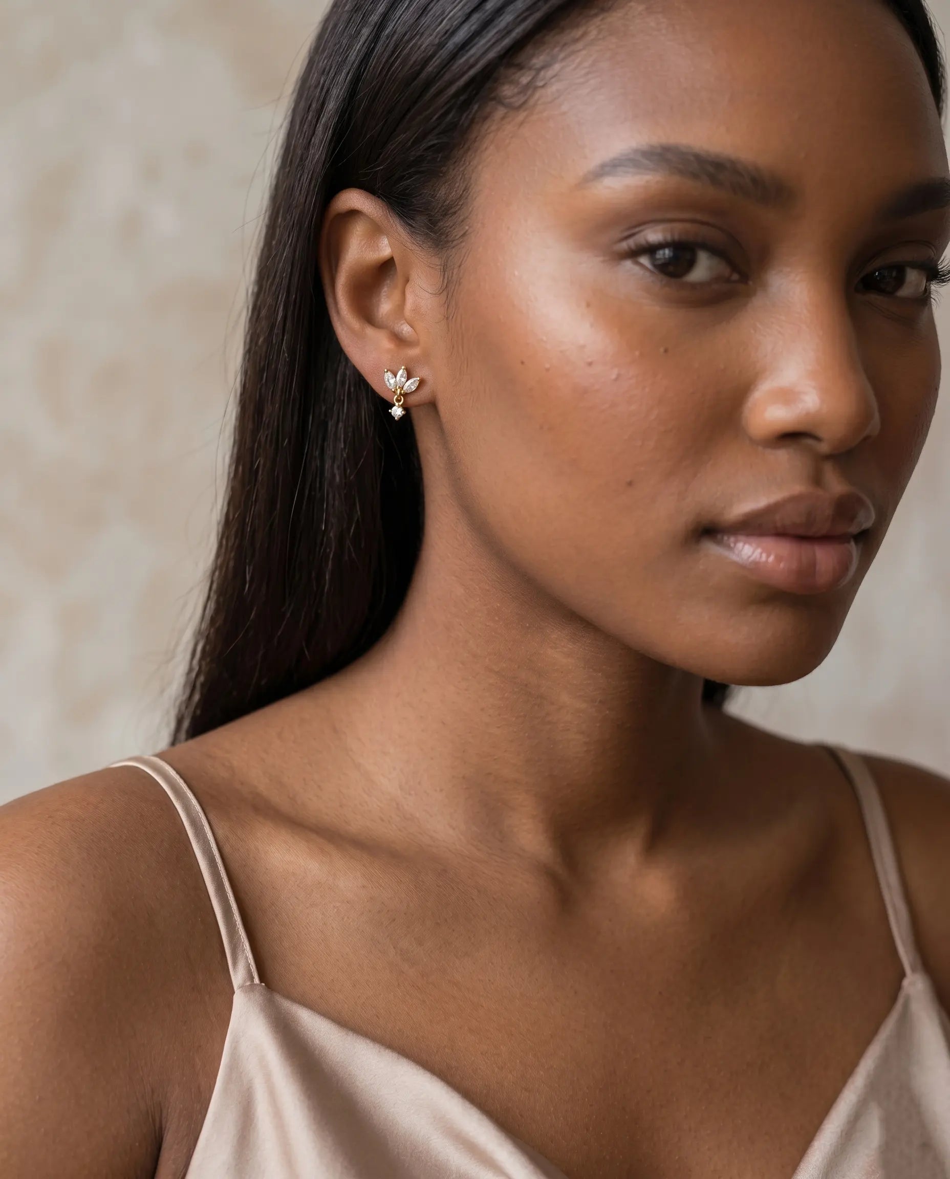 model-wearing-gold-sonea-flower-dangles, elegant-romantic-bloom-jewelry-lifestyle, professional-women-luxury-accessories, chic-floral-earring-photography, luxury-lifestyle-brand-model