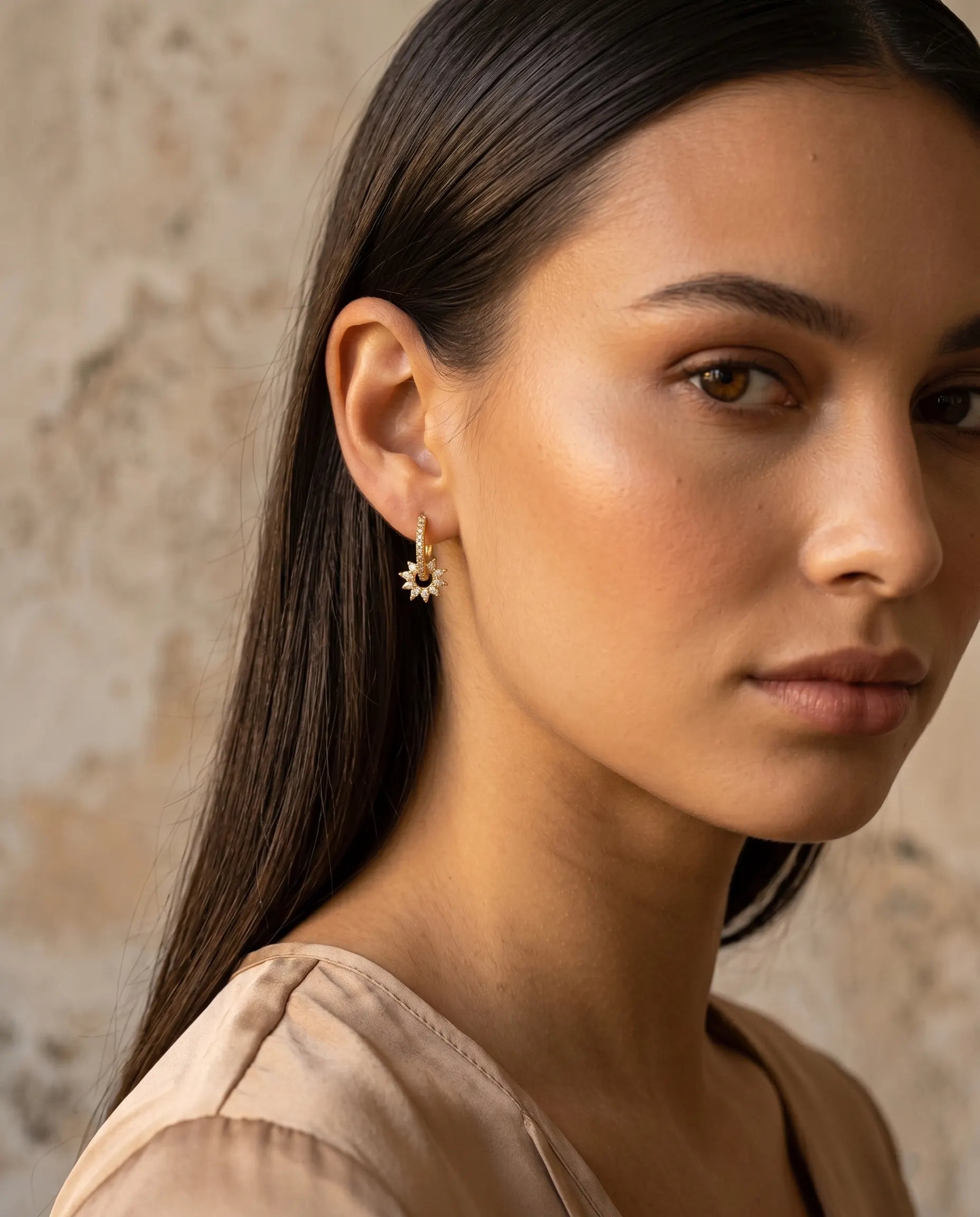 model-wearing-gold-sunlight-sunburst-huggie-earrings-lifestyle, elegant-modern-feminine-jewelry-on-ear, professional-women-luxury-accessories, chic-celestial-gold-styling, luxury-lifestyle-brand-model