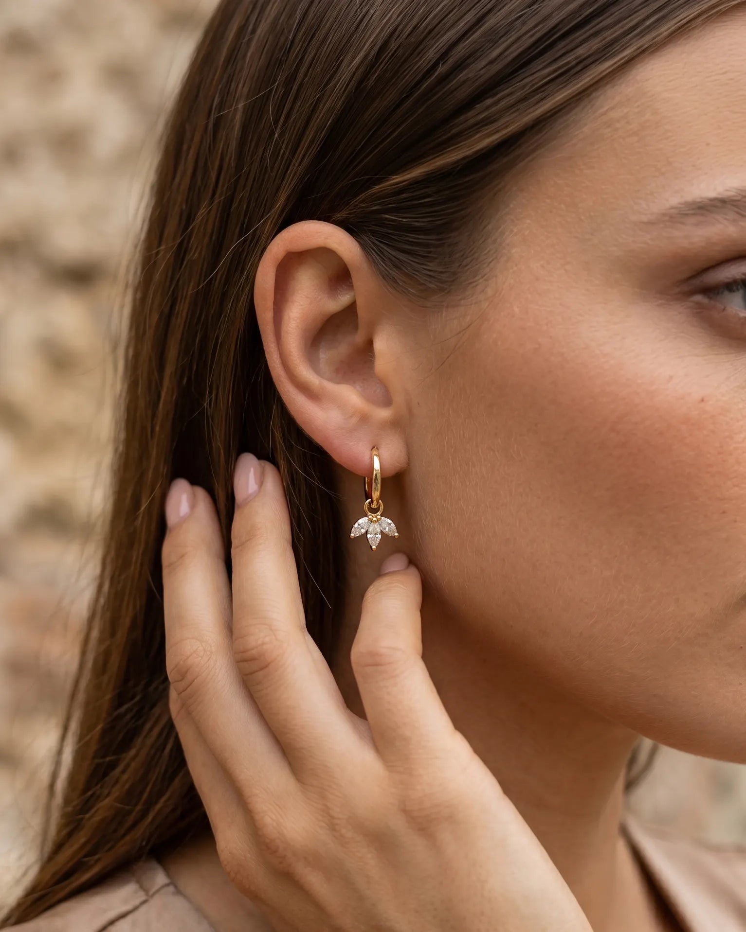model-wearing-gold-sweet-marquise-lotus-huggies-lifestyle, elegant-modern-feminine-jewelry-on-ear, professional-women-luxury-accessories, chic-floral-gold-styling, luxury-lifestyle-brand-model