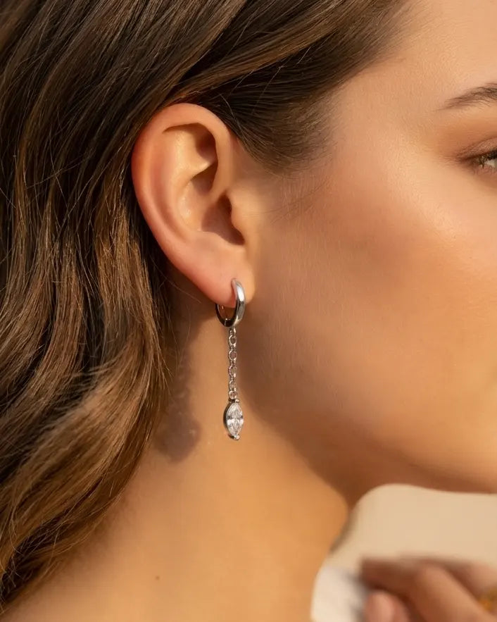 model-wearing-silver-angelique-marquise-drops, elegant-captivating-movement-jewelry-lifestyle, professional-women-luxury-accessories, chic-marquise-cut-earring-photography, luxury-lifestyle-brand-model