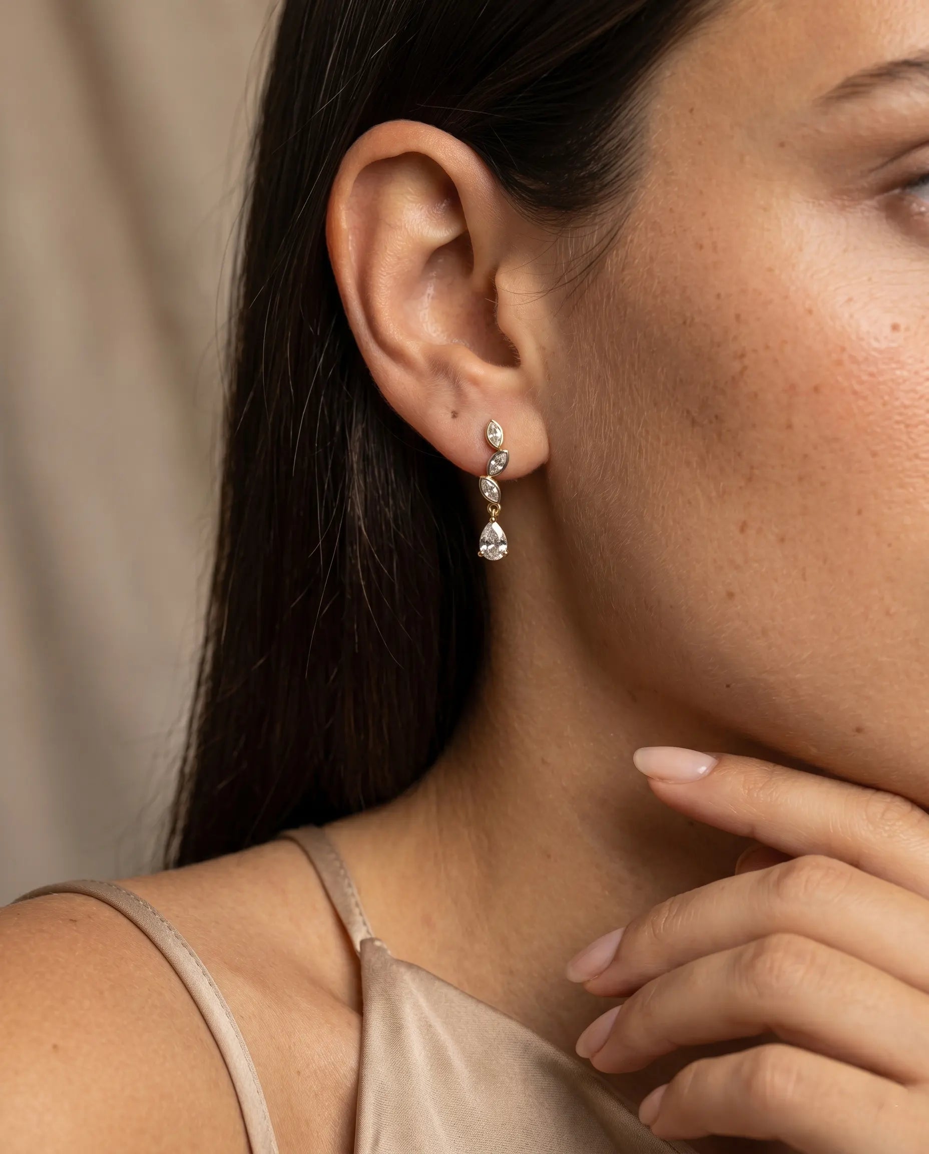 model-wearing-silver-bloselle-teardrop-earrings-lifestyle, elegant-modern-feminine-jewelry-on-ear, professional-women-luxury-accessories, chic-botanical-silver-styling, luxury-lifestyle-brand-model