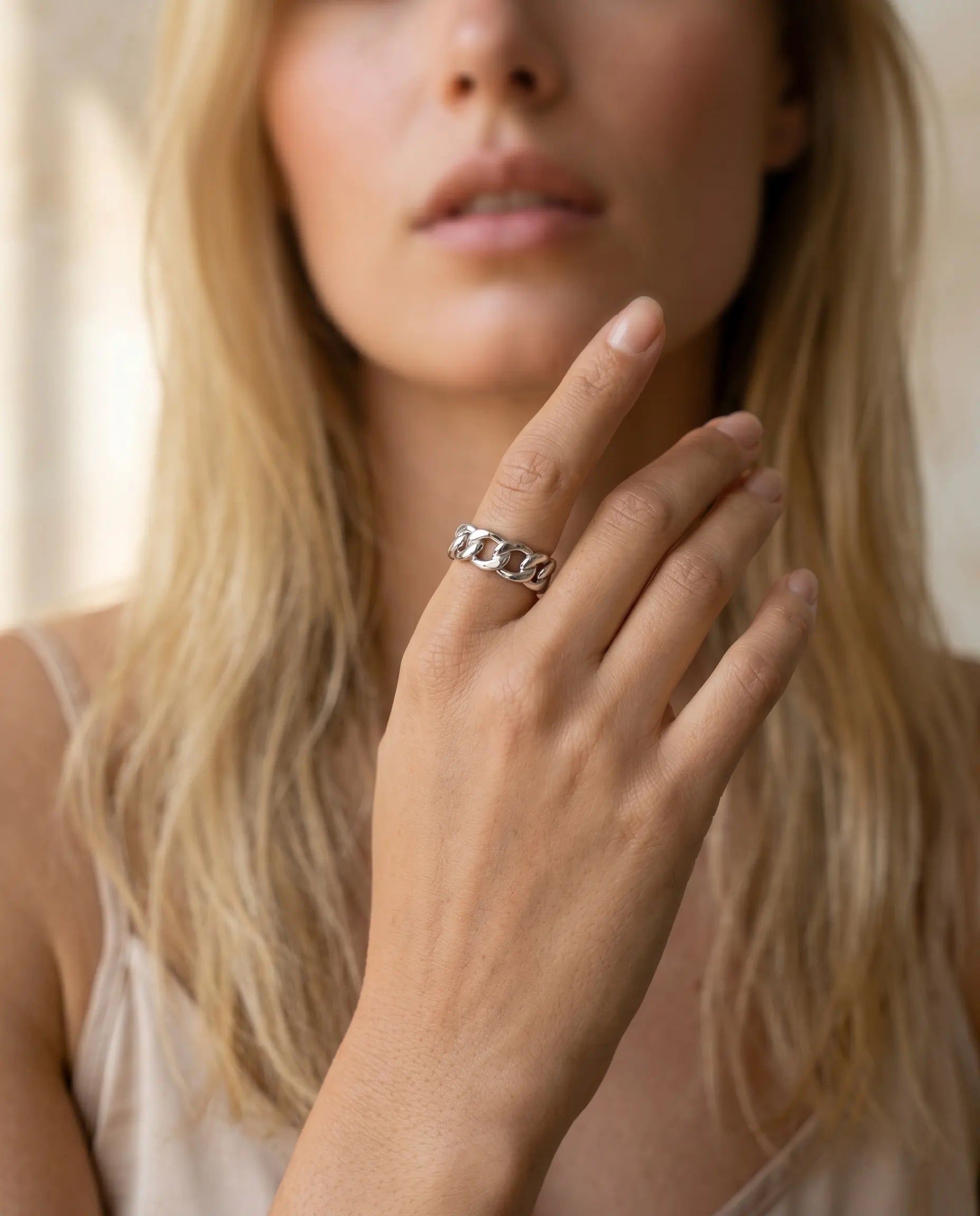 model-wearing-silver-rubia-chain-link-ring-lifestyle, elegant-modern-feminine-jewelry-on-hand, professional-women-luxury-accessories, chic-bold-silver-ring-styling, luxury-lifestyle-brand-model