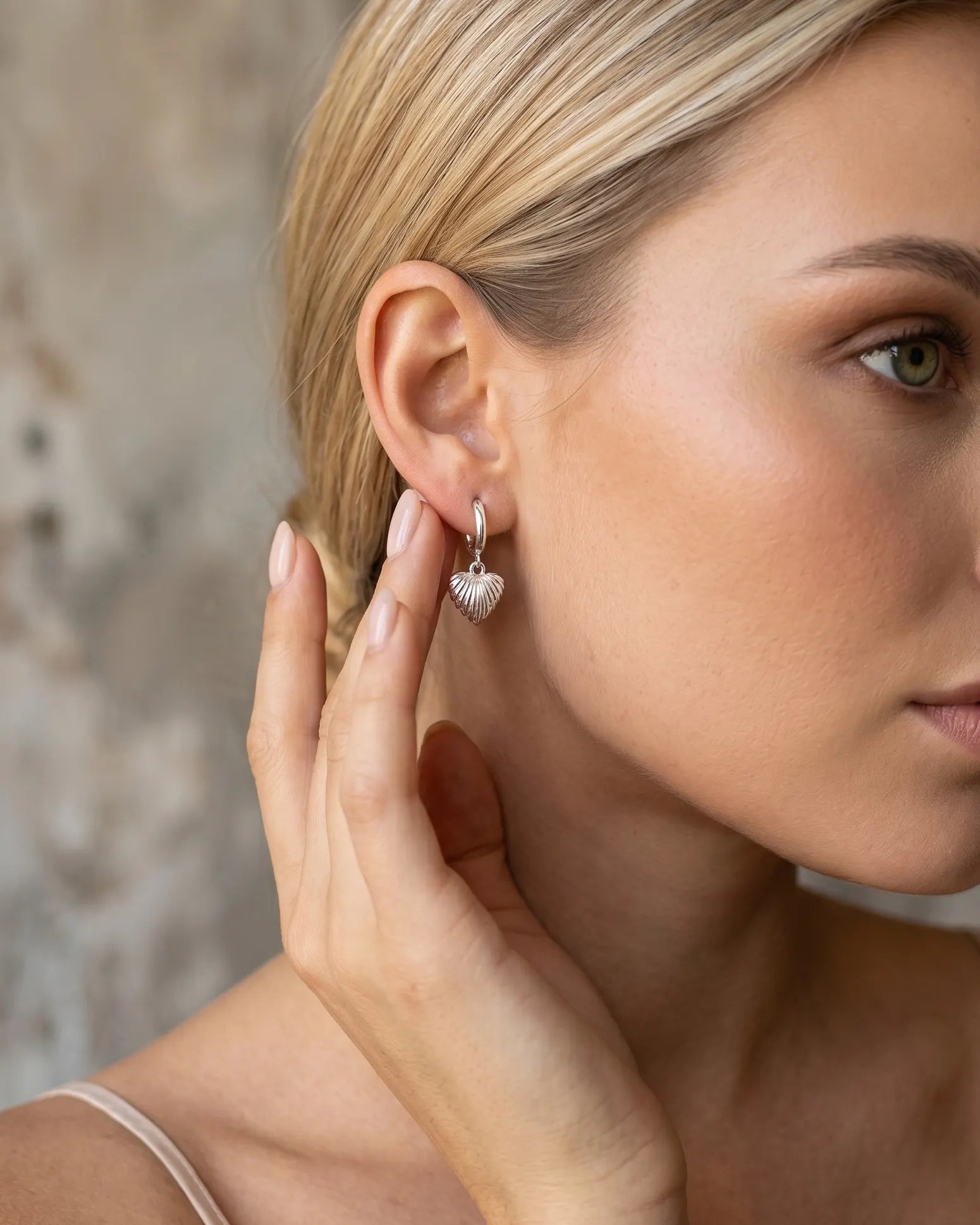 model-wearing-silver-simone-heart-earrings-lifestyle, elegant-modern-feminine-jewelry-on-ear, professional-women-luxury-accessories, chic-heart-silver-styling, luxury-lifestyle-brand-model