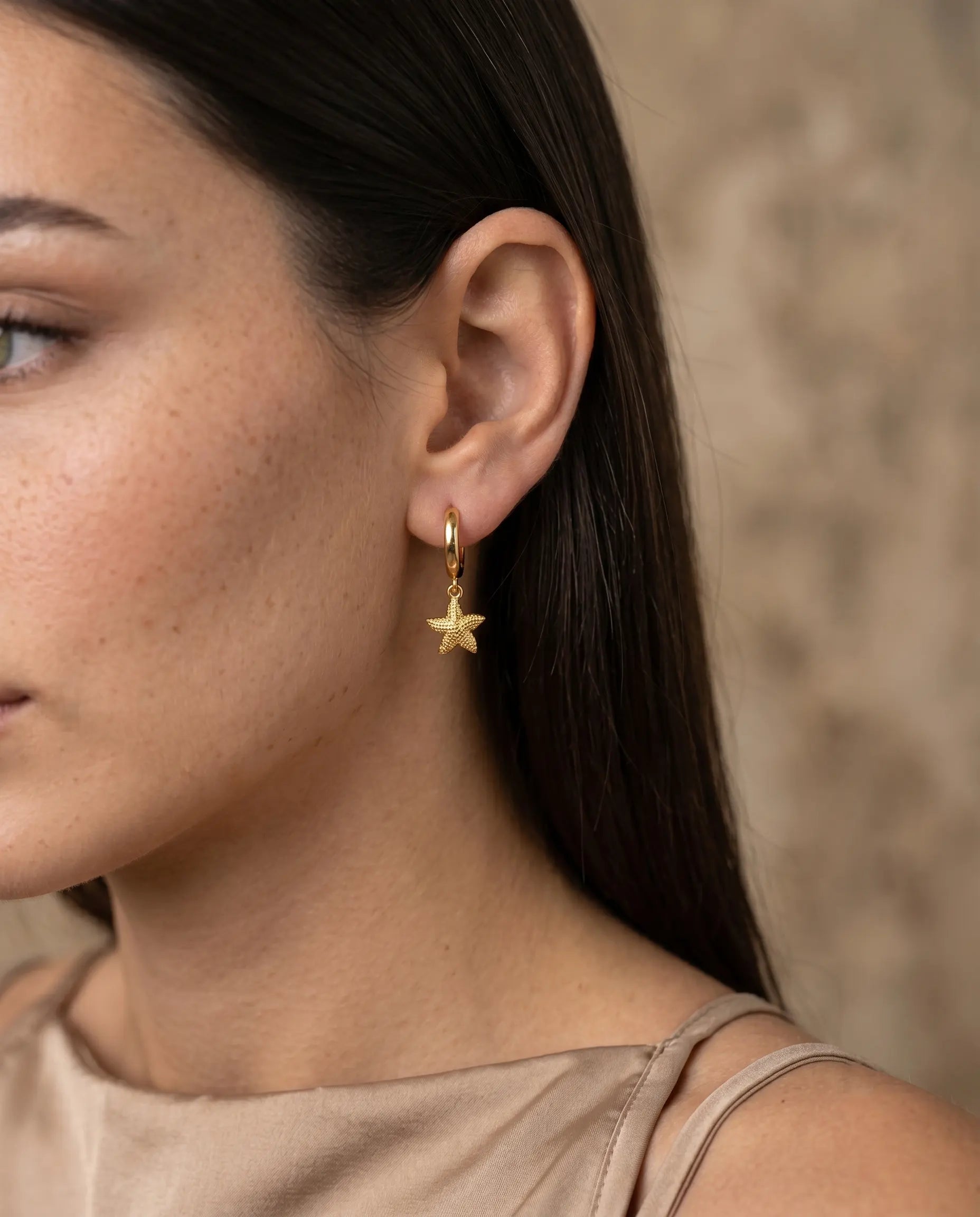 model-wearing-the-nerella-starfish-huggie-hoops-showcasing-sophisticated-minimalist-coastal-ear-styling