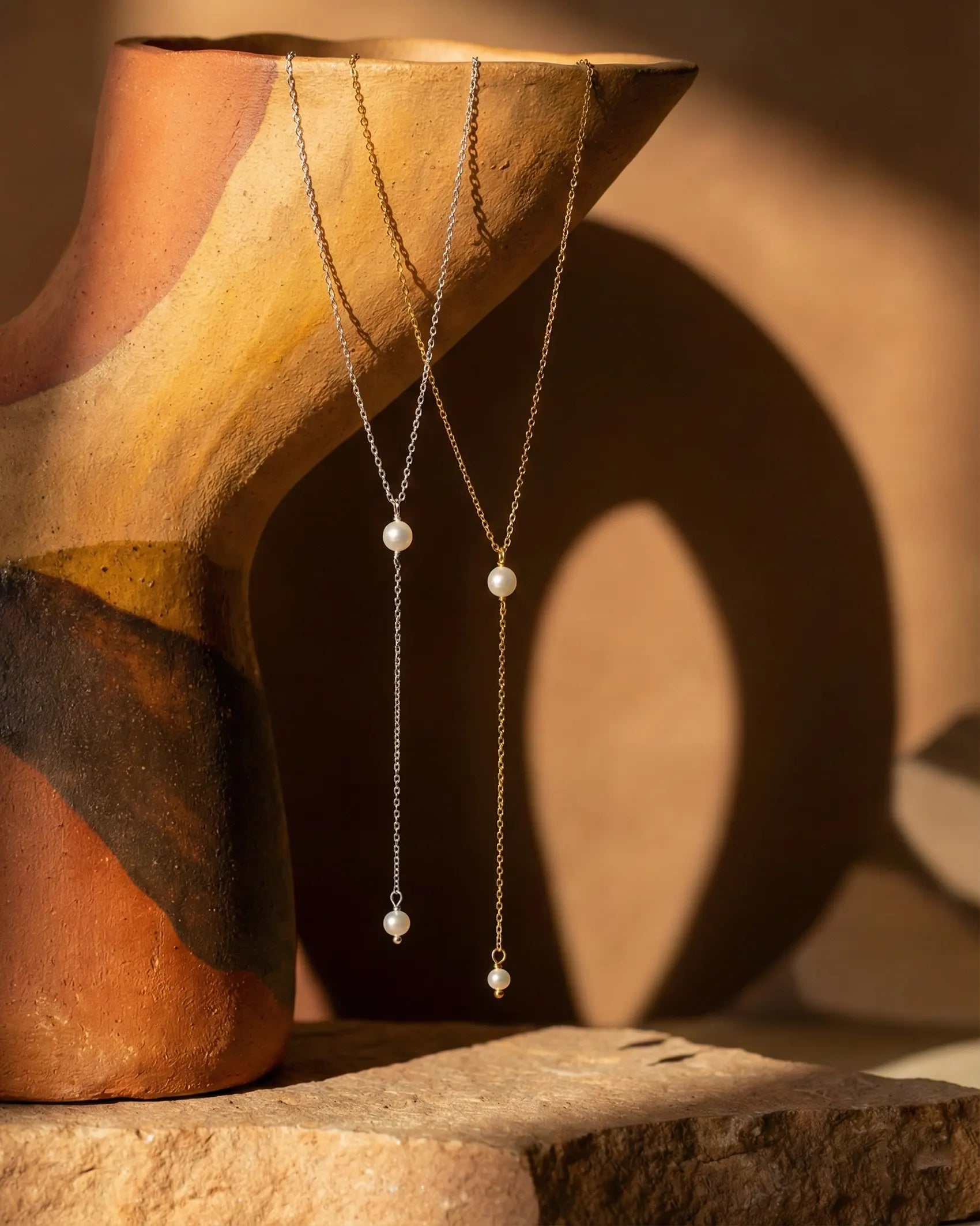 premium-quality-vertical-pearl-necklace, durable-gold-plating-detail-europe, anniversary-gift-pearl-lariat-gold, refined-minimalist-jewelry-aesthetic, sustainable-steel-jewelry-brand-europe, holiday-gift-guide-pearl-luxury