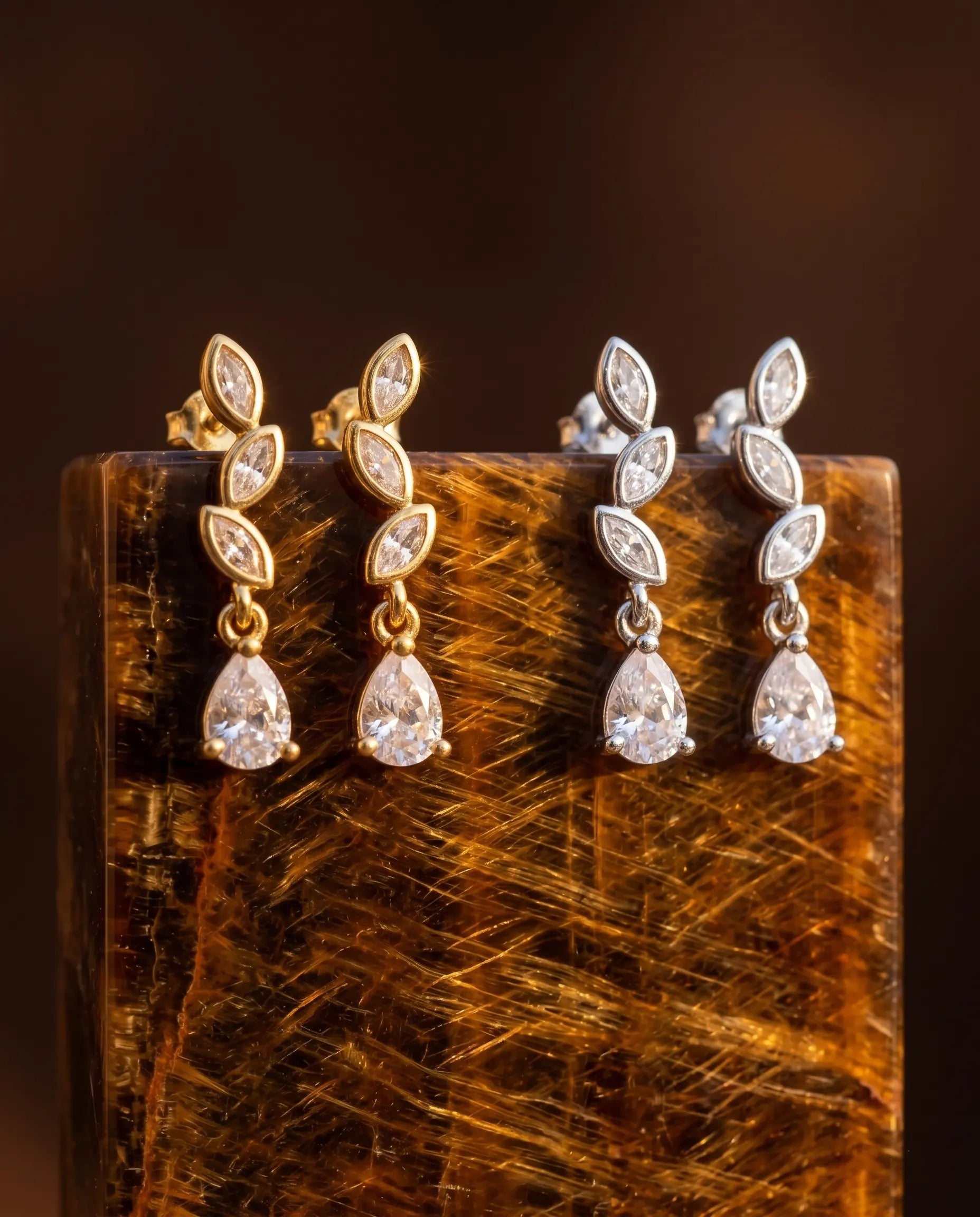 timeless-glamorous-aesthetic-bloselle-sparkling-earrings-gold-silver, 18k-gold-finish-detail-solitaire-drops, gift-ideas-for-women-elegant-sparkle-jewelry, luxury-boutique-jewelry-netherlands, artistic-jewelry-flatlay-photography