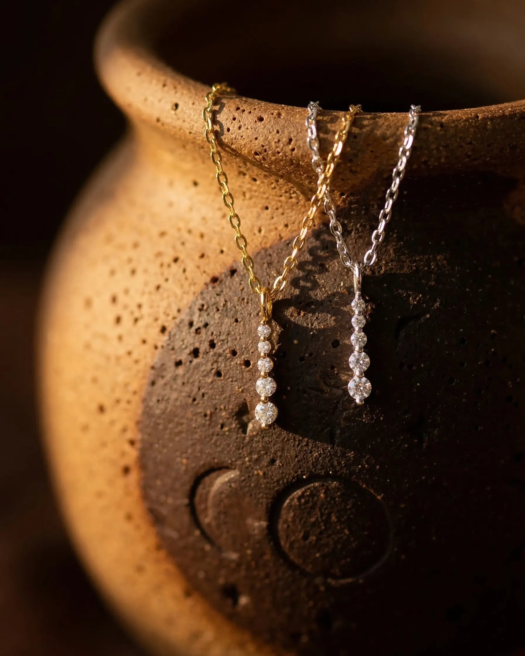 timeless-minimalist-aesthetic-pear-necklace-gold, 18k-gold-vermeil-finish-detail-triple-drop-pendant, gift-ideas-for-women-sparkling-teardrop-jewelry, luxury-boutique-jewelry-netherlands, artistic-jewelry-flatlay-photography