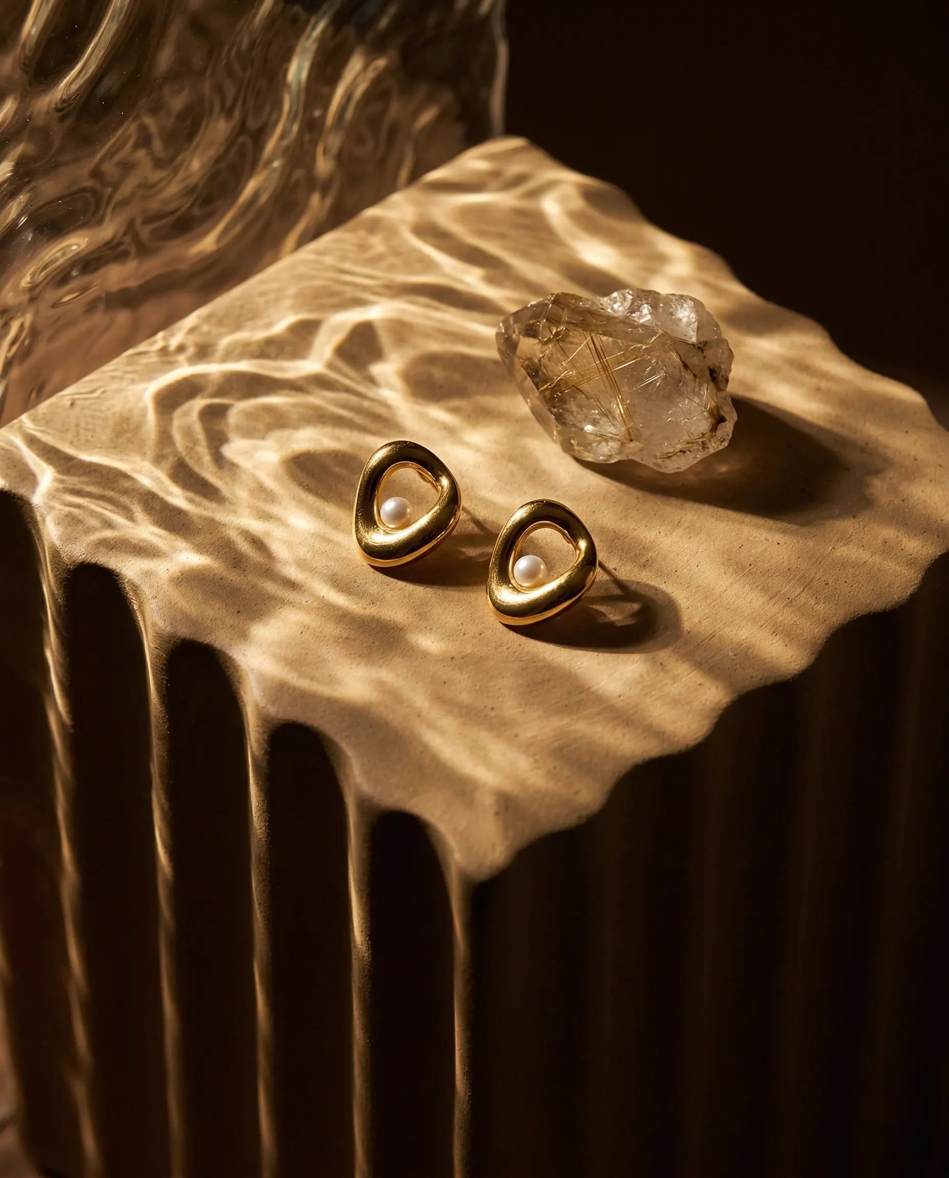 timeless-modern-aesthetic-cybelle-sparkling-teardrop-earrings-gold-silver, 18k-gold-pvd-finish-detail-drop-hoops, gift-ideas-for-women-elegant-waterproof-jewelry, luxury-boutique-jewelry-netherlands, artistic-jewelry-flatlay-photography