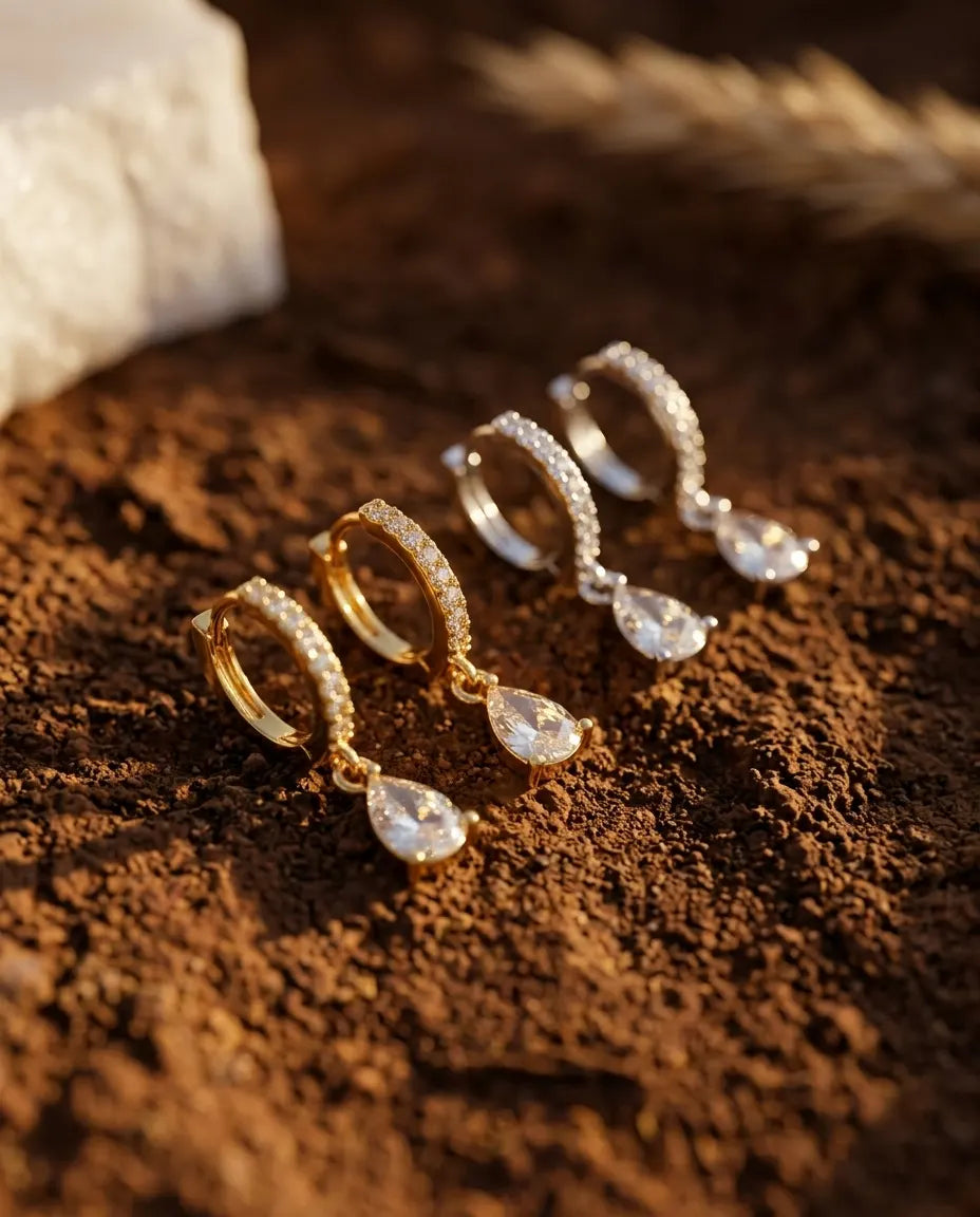 timeless-teardrop-aesthetic-huggie-earrings-modern, premium-plating-detail-quiola-earrings, gift-ideas-for-women-sparkling-jewelry, luxury-boutique-jewelry-netherlands, artistic-jewelry-flatlay-photography