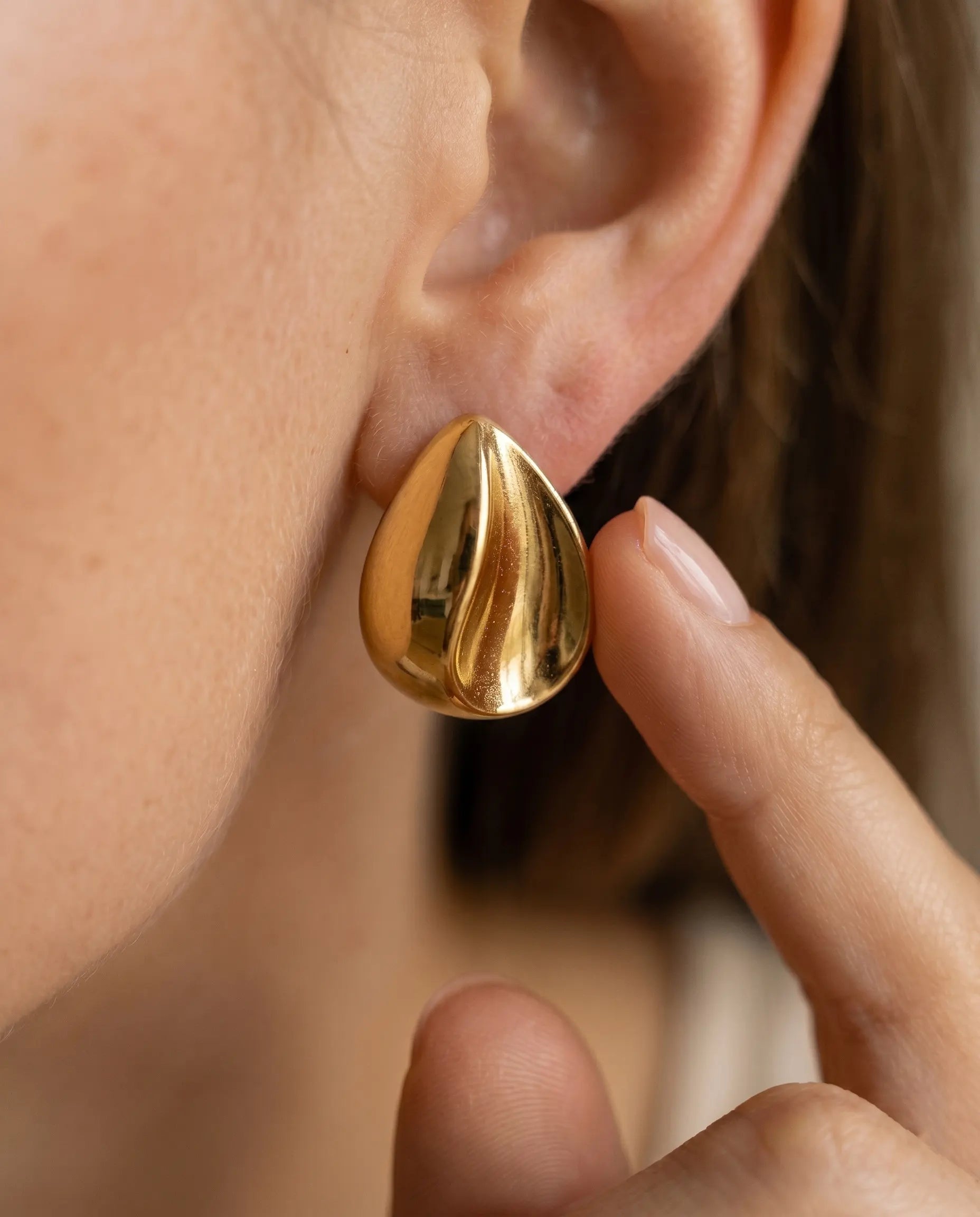 versatile-daily-wear-gold-rhea-statement-studs, effortless-high-end-sculptural-luxe-style, minimalist-accessories-for-refined-look, classy-316l-steel-teardrop-earrings-lifestyle, senya-jewelry-rhea-collection