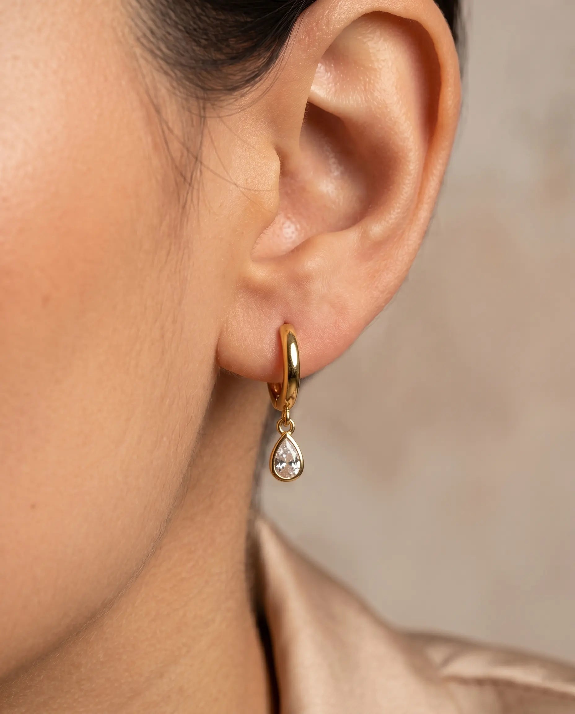 versatile-daily-wear-teardrop-sparkle-earrings, effortless-elegance-jewelry-style, minimalist-accessories-for-special-occasions, classy-gold-925-silver-earrings-lifestyle, high-shine-fairy-collection-huggies, senya-jewelry-earring-detail